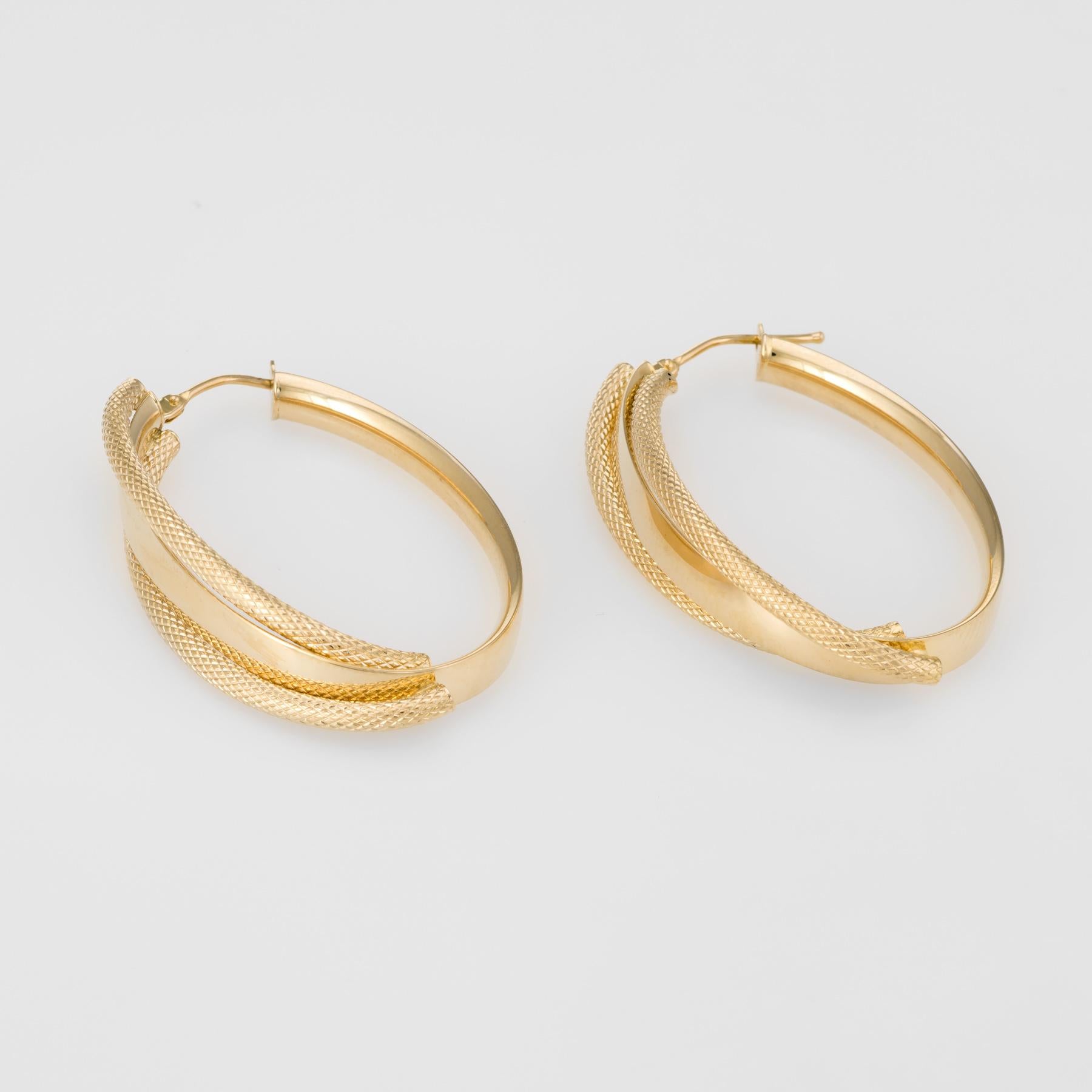 Elegant pair of textured hoop earrings, crafted in 14k yellow gold. 

The lightweight earrings (3.2 grams) have a bold look and are very comfortable to wear.   

The earrings feature lever backings.

The earrings are in excellent original