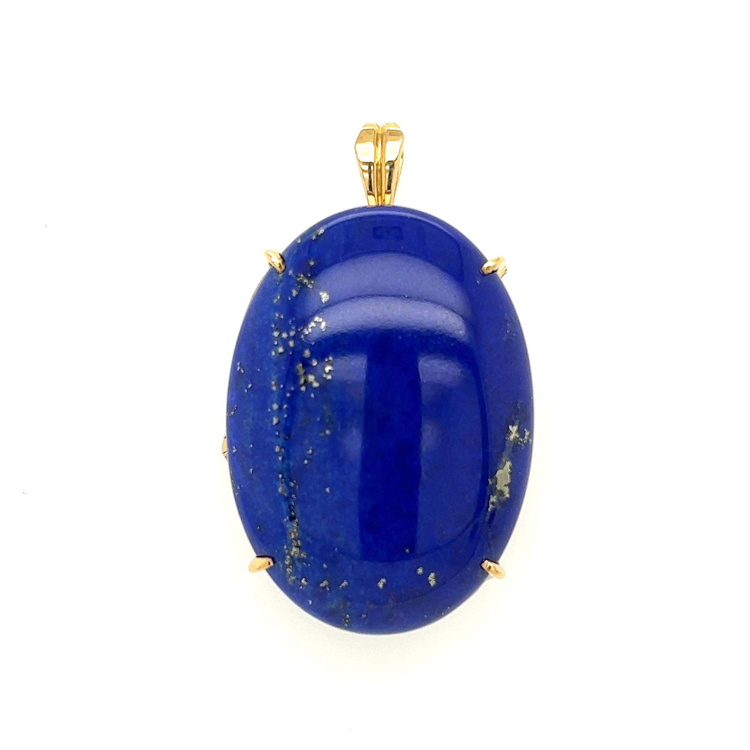 Simply Beautiful! Large Oval Lapis Lazuli Gold Pendant Brooch. Securely centered by a Large Oval Cabochon Laps w/Pyrite. Hand-crafted 18K Yellow Gold mounting. Approx. Dimensions: 1.7” l x 1” w x 0.6” h. More Beautiful in real time...Sure to be