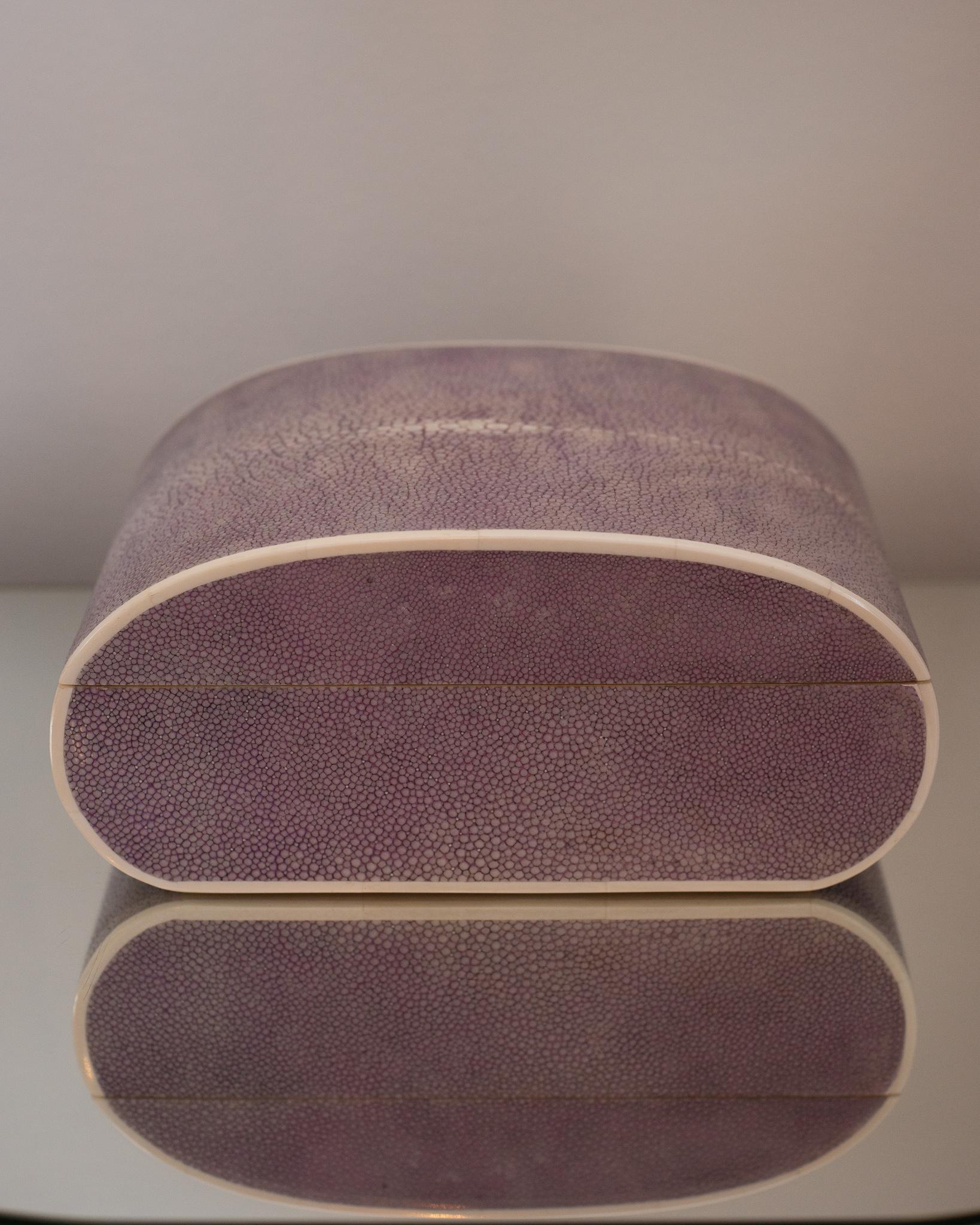 A semi round oval lavender shagreen decorative box finished with bone, sycamore and a felt interior. Maison Nurita’s Shagreen boxes are more than just decorative, they can be a special place to hold your coveted jewelry, love letters or sentimental