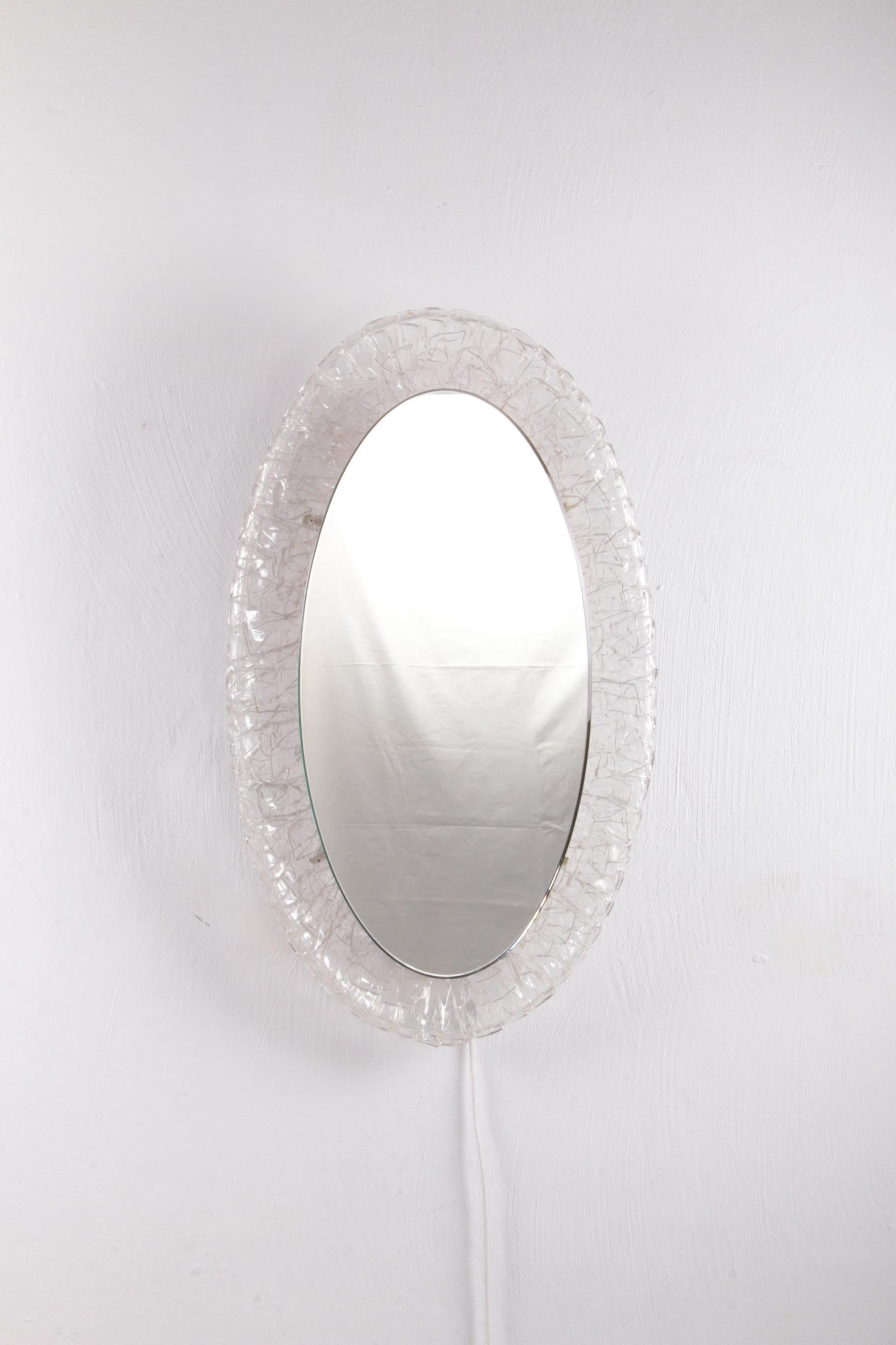 Large oval Plexiglas mirror with lighting, 1960 Germany.


The oval mirror is made of metal with plexiglass and was produced in the 1960s.

The mirror has interior lighting which emits a warm soft light when it is on. The mirror is in very good