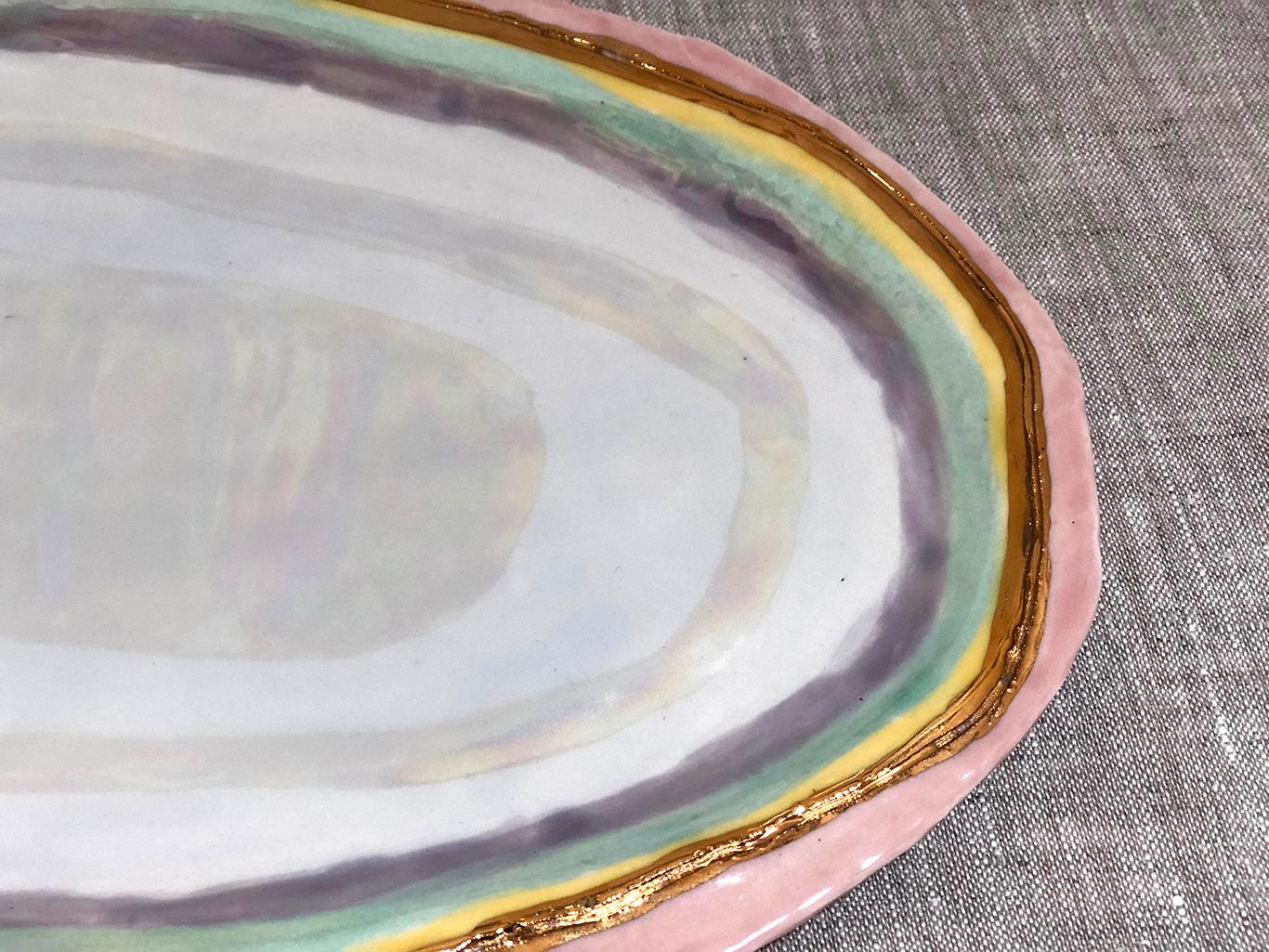 This large oval ceramic Halo Patter by Minh Singer is made from hand-built porcelain with rainbow celadon glazes and mother of pearl and 22-karat gold lusters. Singer's mesmerizing technique requires several firings.

13
