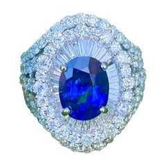 Large Oval Shaped Vivid Blue Sapphire and Diamond 7.20 Carat 18 Karat Gold Ring