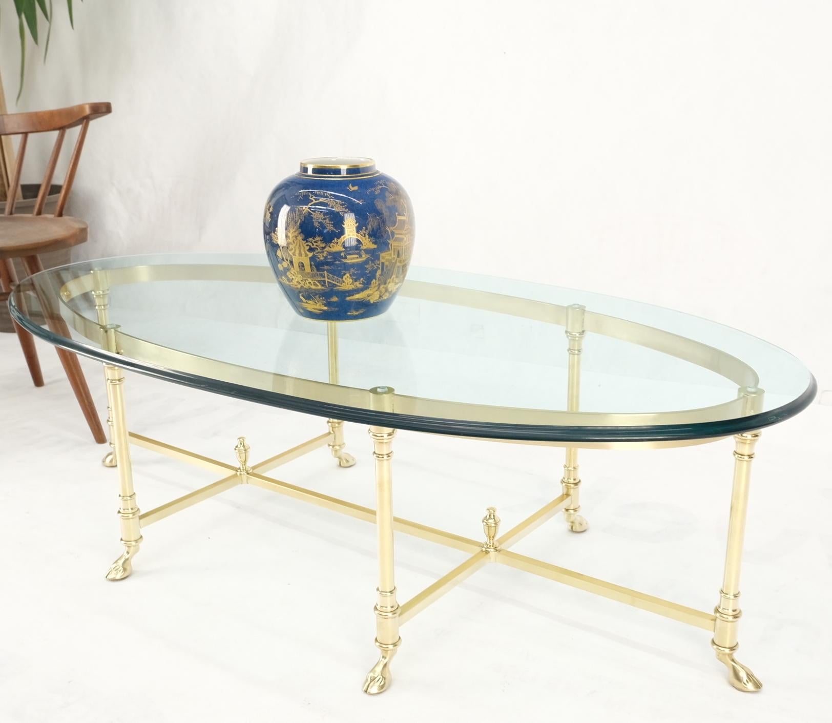 Large oval solid brass glass top hoof feet Italian coffee table.