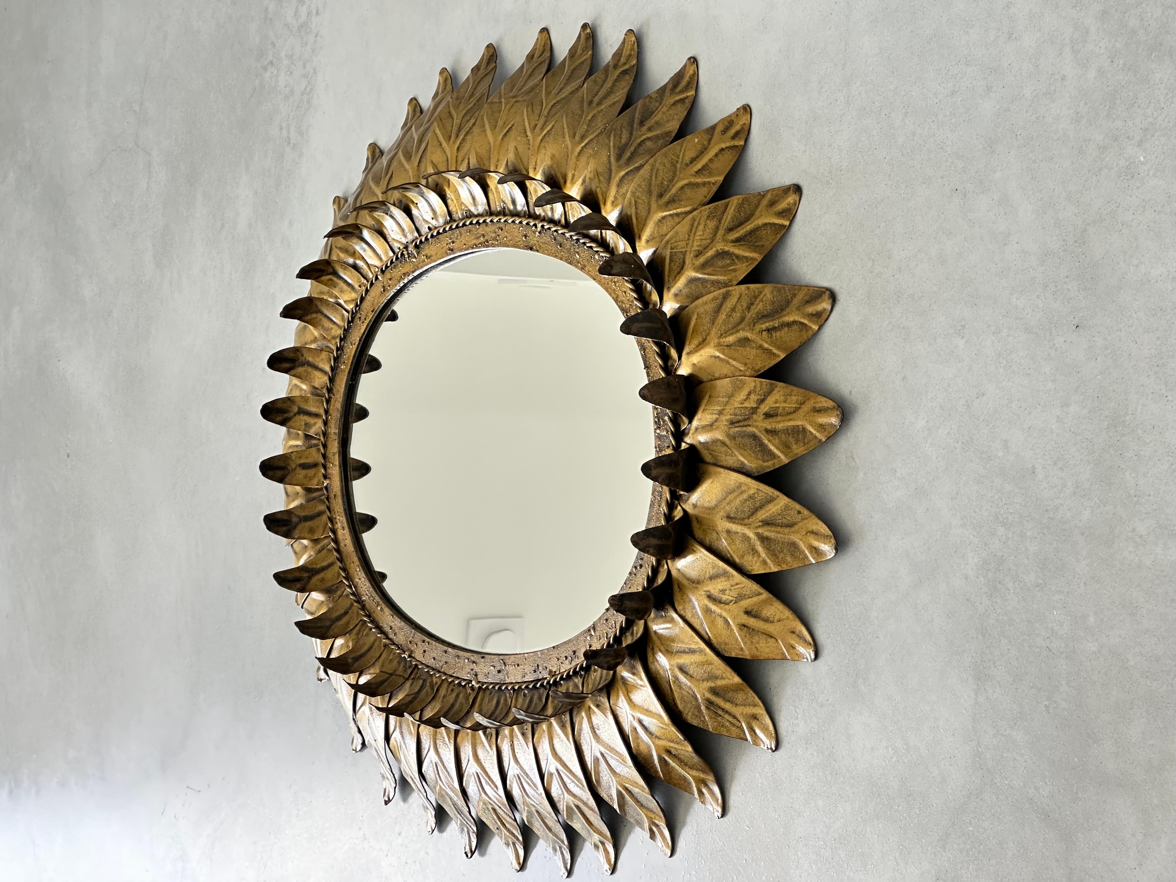 Spanish Colonial Large oval sunburst mirror, framed with gold-colored metal leaves, Spain 1960 For Sale