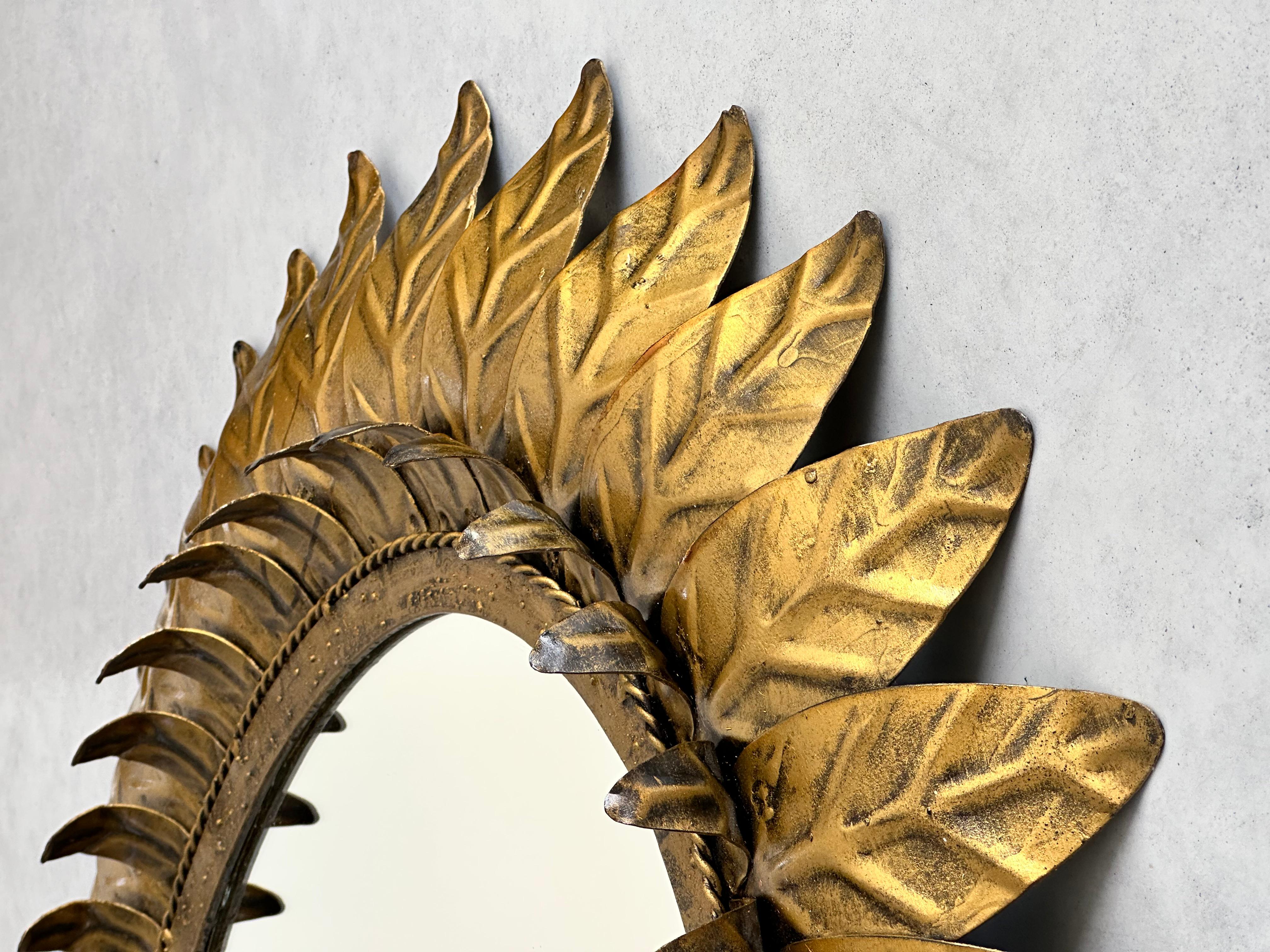 Metalwork Large oval sunburst mirror, framed with gold-colored metal leaves, Spain 1960 For Sale