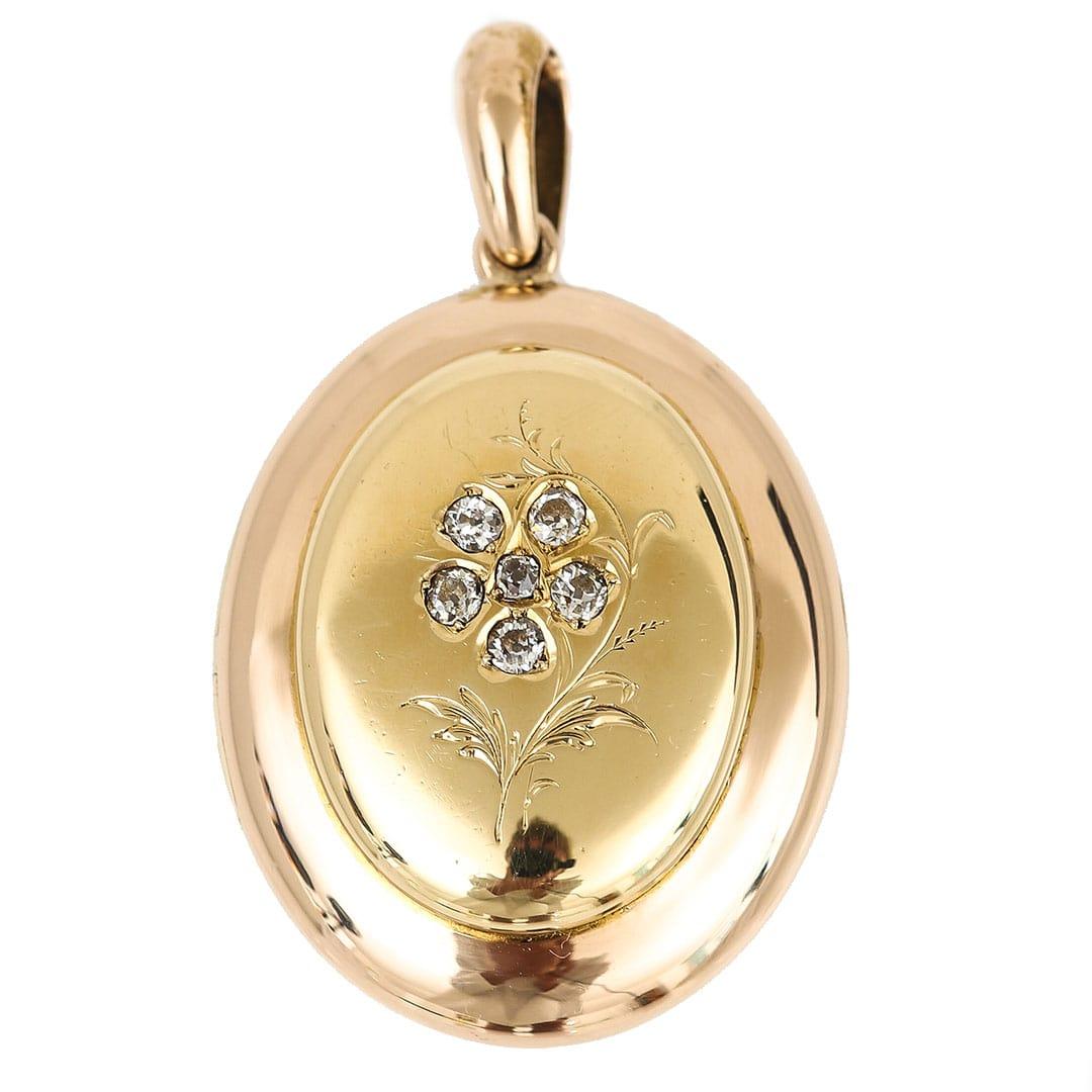 A large and impressive oval Victorian 18ct yellow gold Forget Me Not rose cut diamond locket pendant that was made circa 1870. The central oval depicts a hand engraved pansy the petals of which are set with rose cut diamonds. The use of the Forget