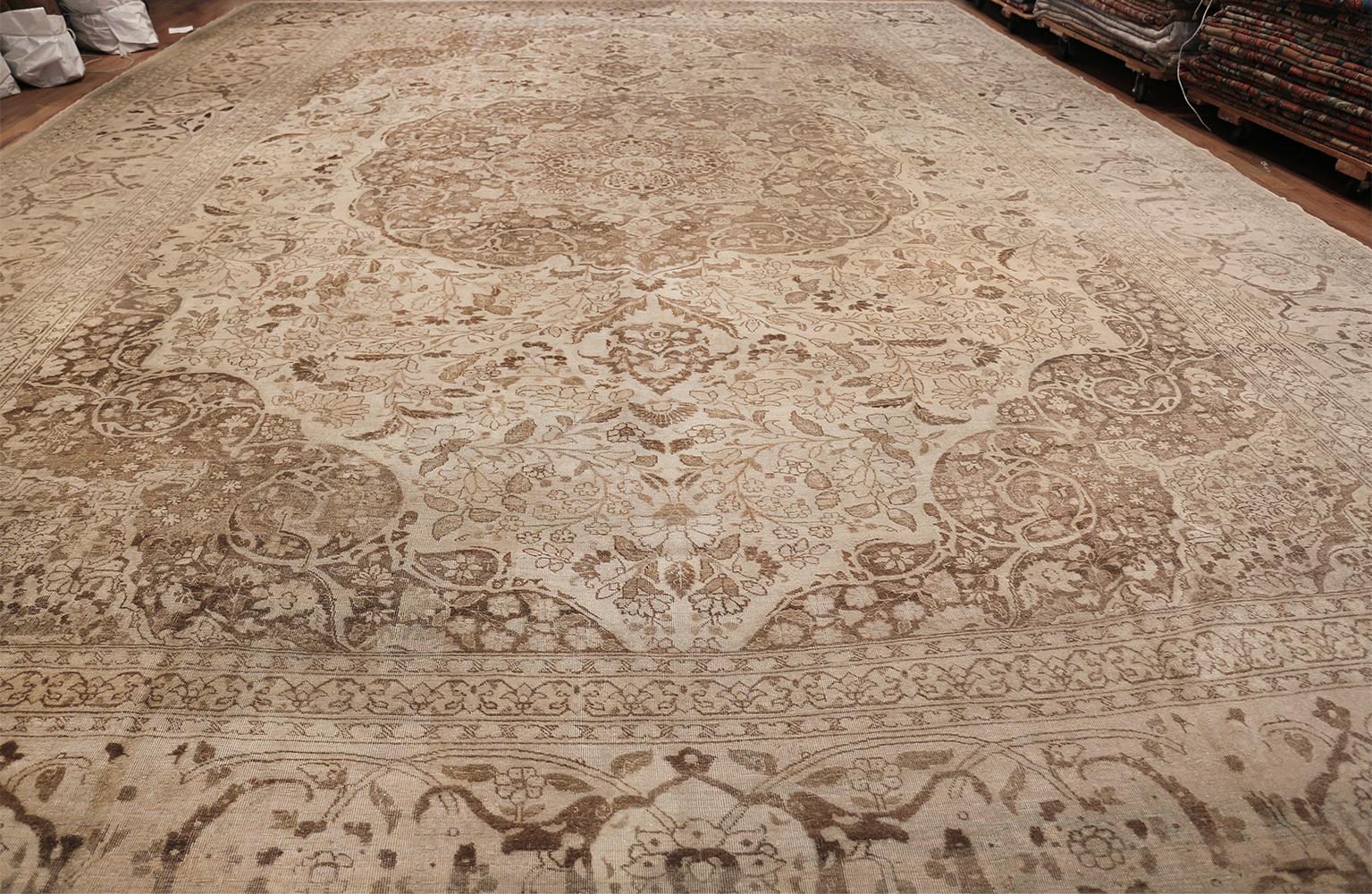 Beautiful large oversized antique Persian Tabriz rug, Country of Origin: Persia, circa 1900. Size: 16 ft x 23 ft (4.88 m x 7.01 m)

The earthy browns and delicate ivory of this Tabriz carpet from around the turn of the 20th century create a piece