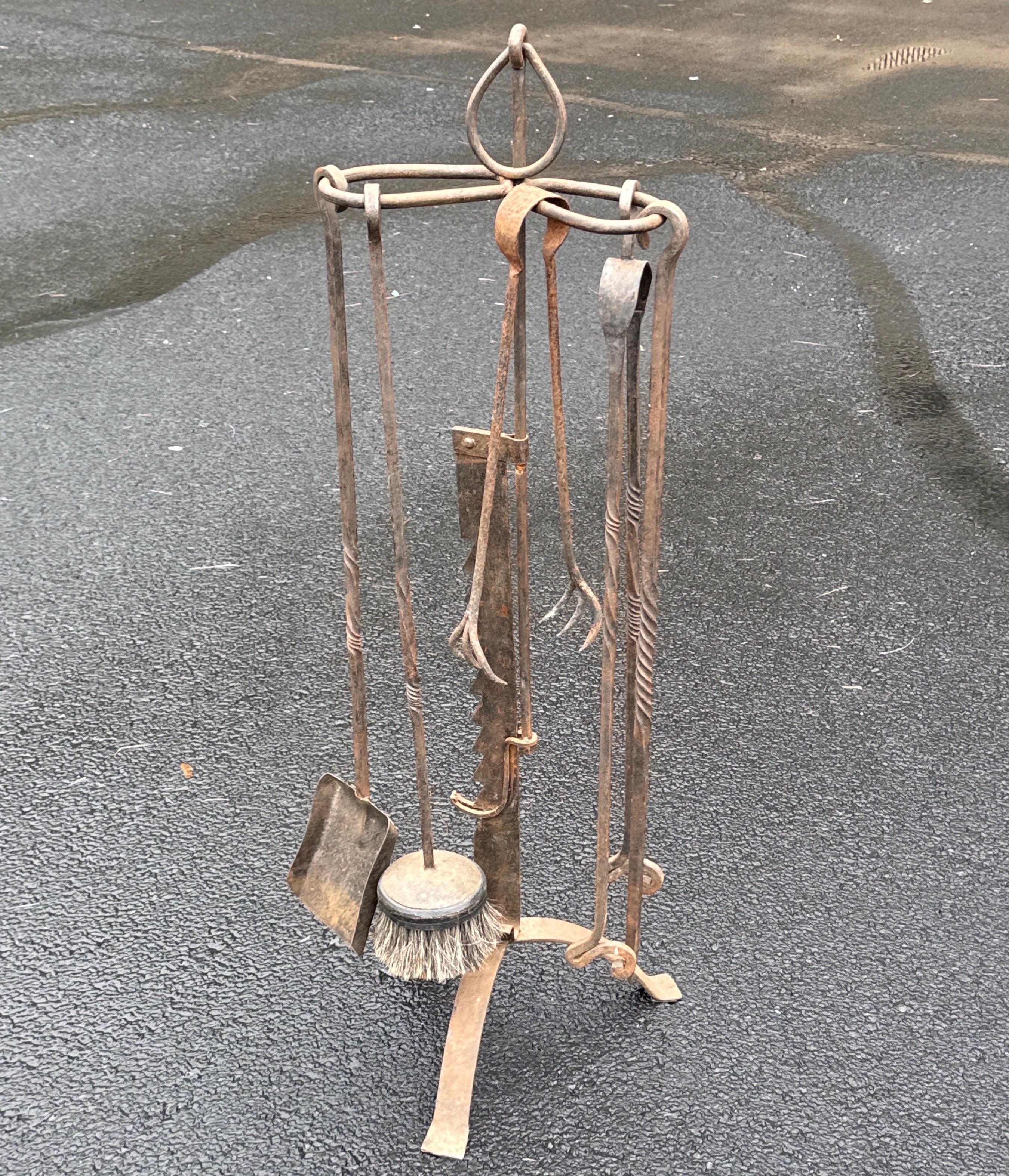 This fantastic collection of European estate fireplace tools dates Mid-20th Century. This 5 piece set includes 2 tongs, brush, shovel and poker. The smaller tongs purpose is to load fresh firewood, the second larger is to move around hot burning