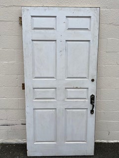 Large Oversized Raised Panel Exterior Entrance Door with Brass Hardware.