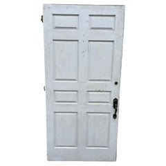 Large Oversized Raised Panel Exterior Entrance Door with Brass Hardware.