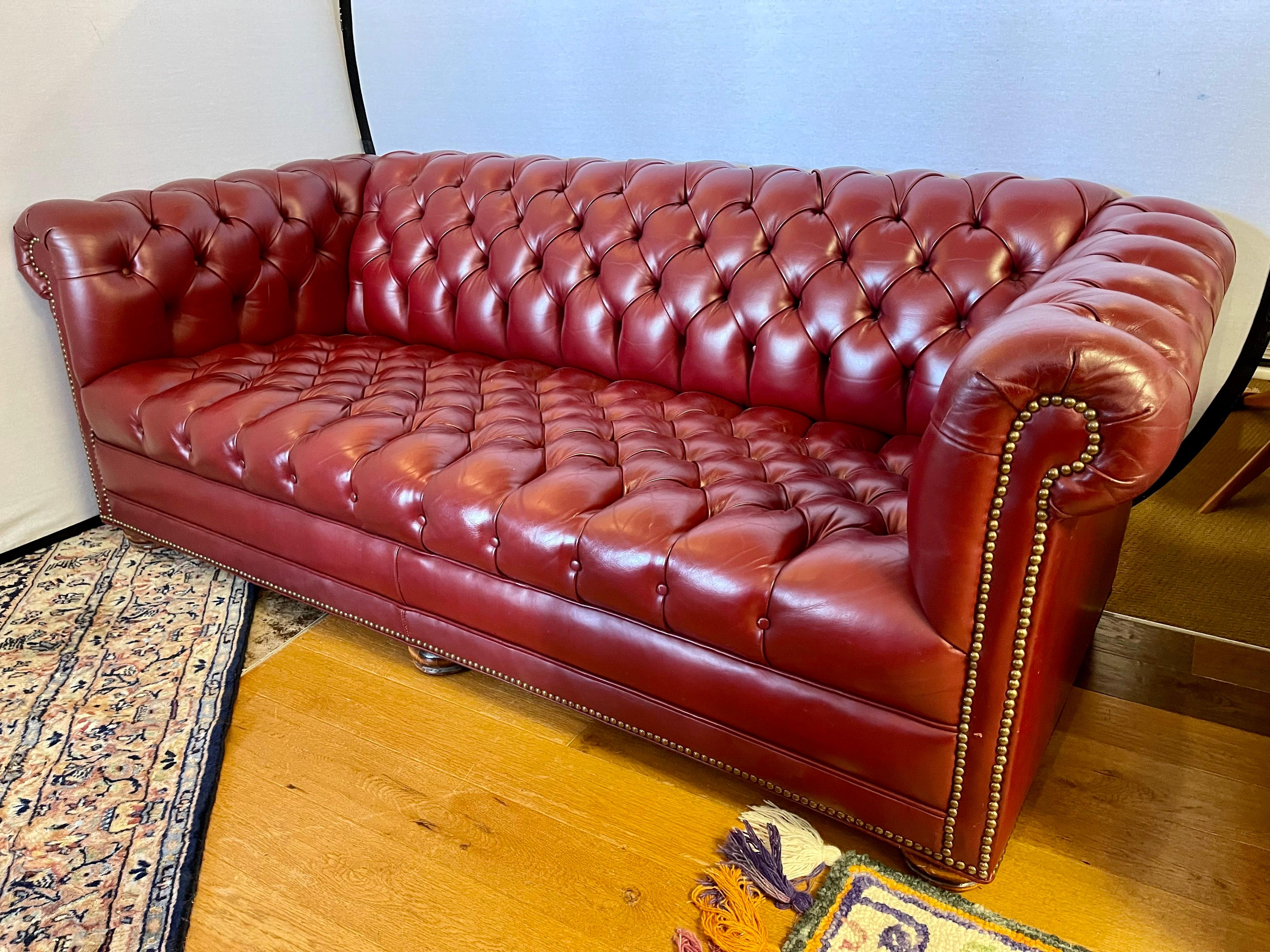 Stunning vintage oxblood burgundy red leather chesterfield sofa with rare button tufting throughout including the seating. All dimensions are below and, unlike many chesterfields, this one sports eight-way hand tied construction so that it is