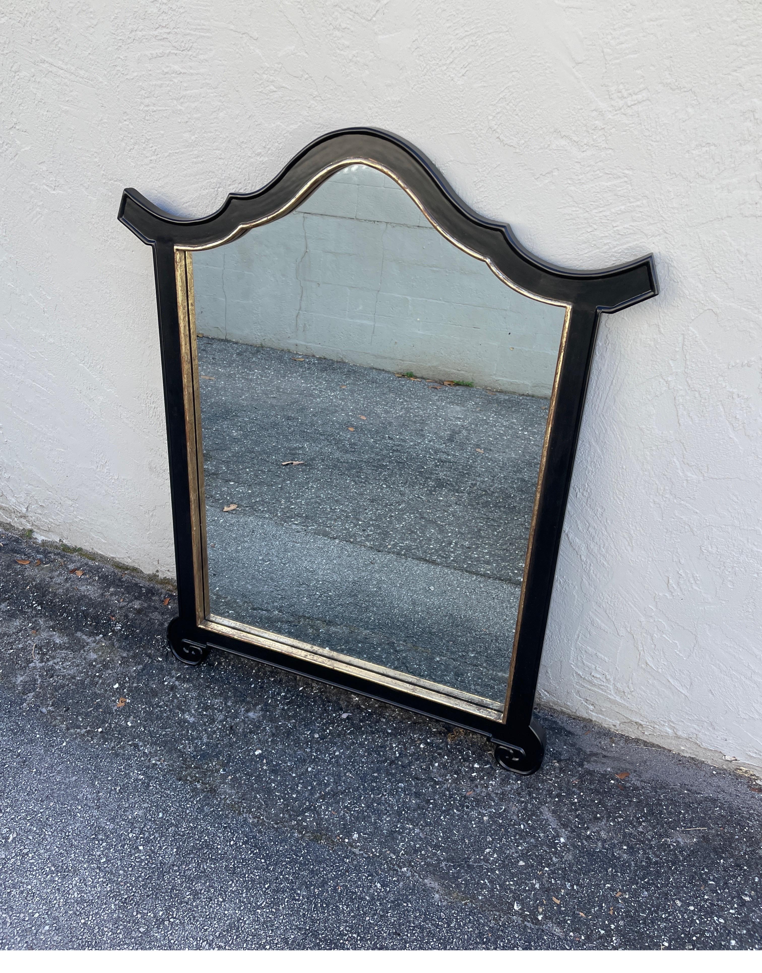 Vintage large Pagoda style wall mirror finished in black with gold trim. A very simple, yet elegant mirror.