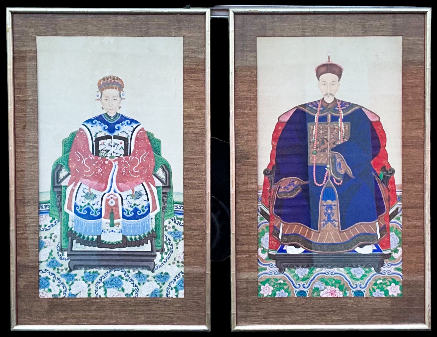 These hand painted Chinese hand painted ancestral portrait are antique scrolls in mid-century silver gilt faux bamboo frames with grasscloth matting. They represent a wealthy husband and wife. Their large scale and vivid coloration give them