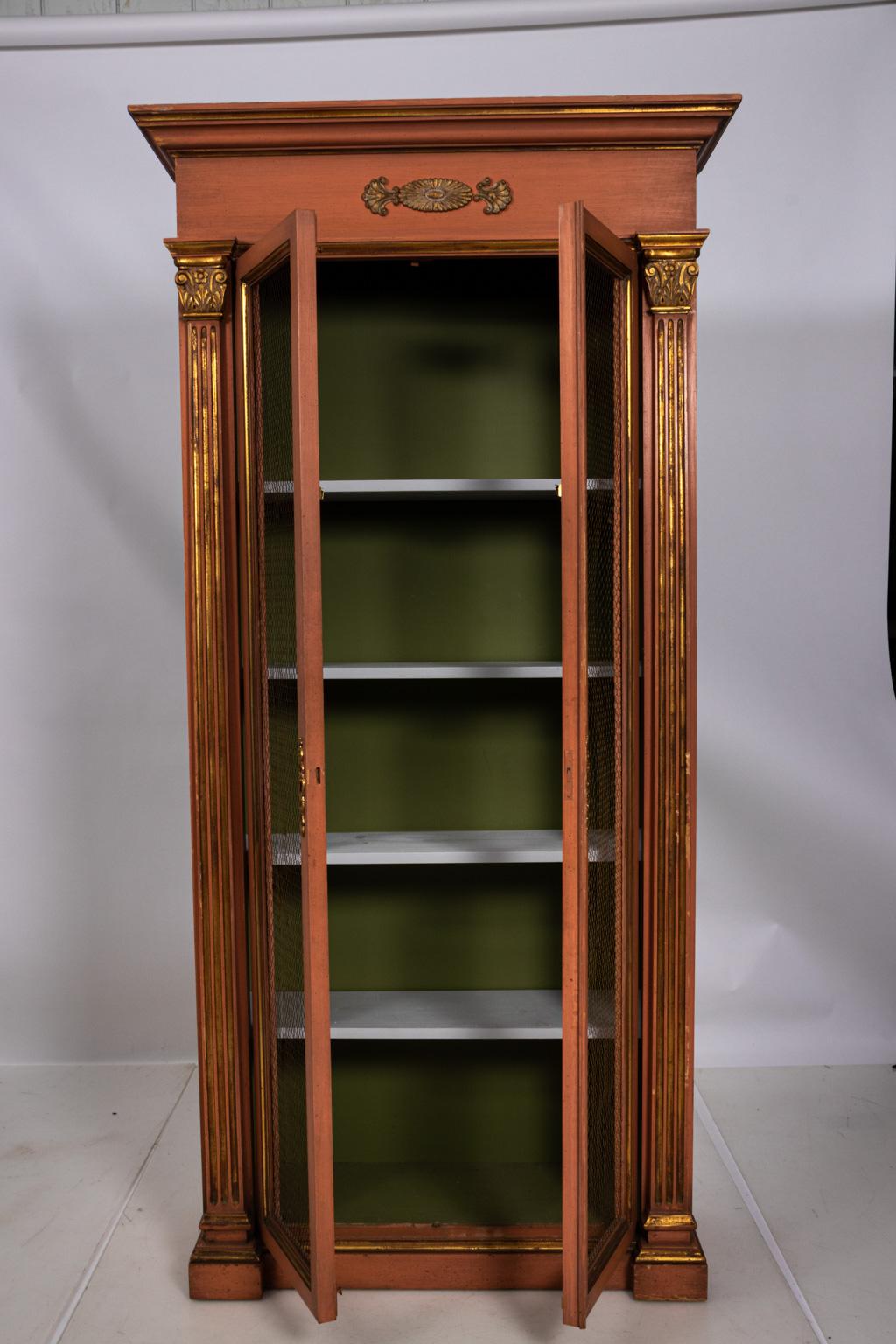 Neoclassical style large scale painted Folk Art display cabinet from a pocket knife store, circa 1950s. Fully opens and closes with multiple shelves. Please note of wear consistent with age including damage to metal screen, minor oxidation, and