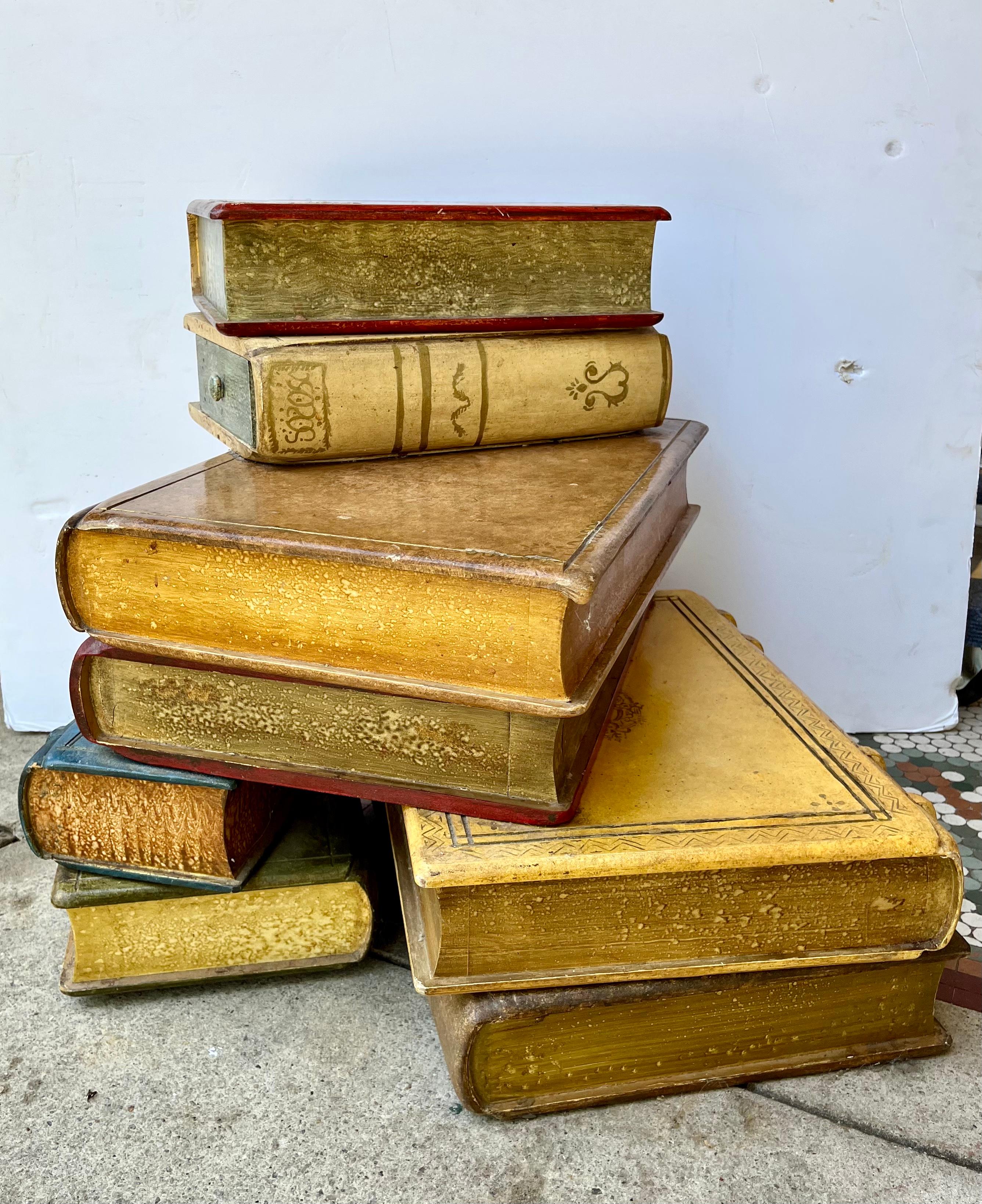 Colorful faux Books as a low table with two not-so-obvious drawers .All four stacks connected as one table .

Provenance : Sir Rex Harrison ,Oscar Winner - Best Actor for Lead in My Fair Lady . Sculpted  and polychrome painted ,gilt decorated wood
