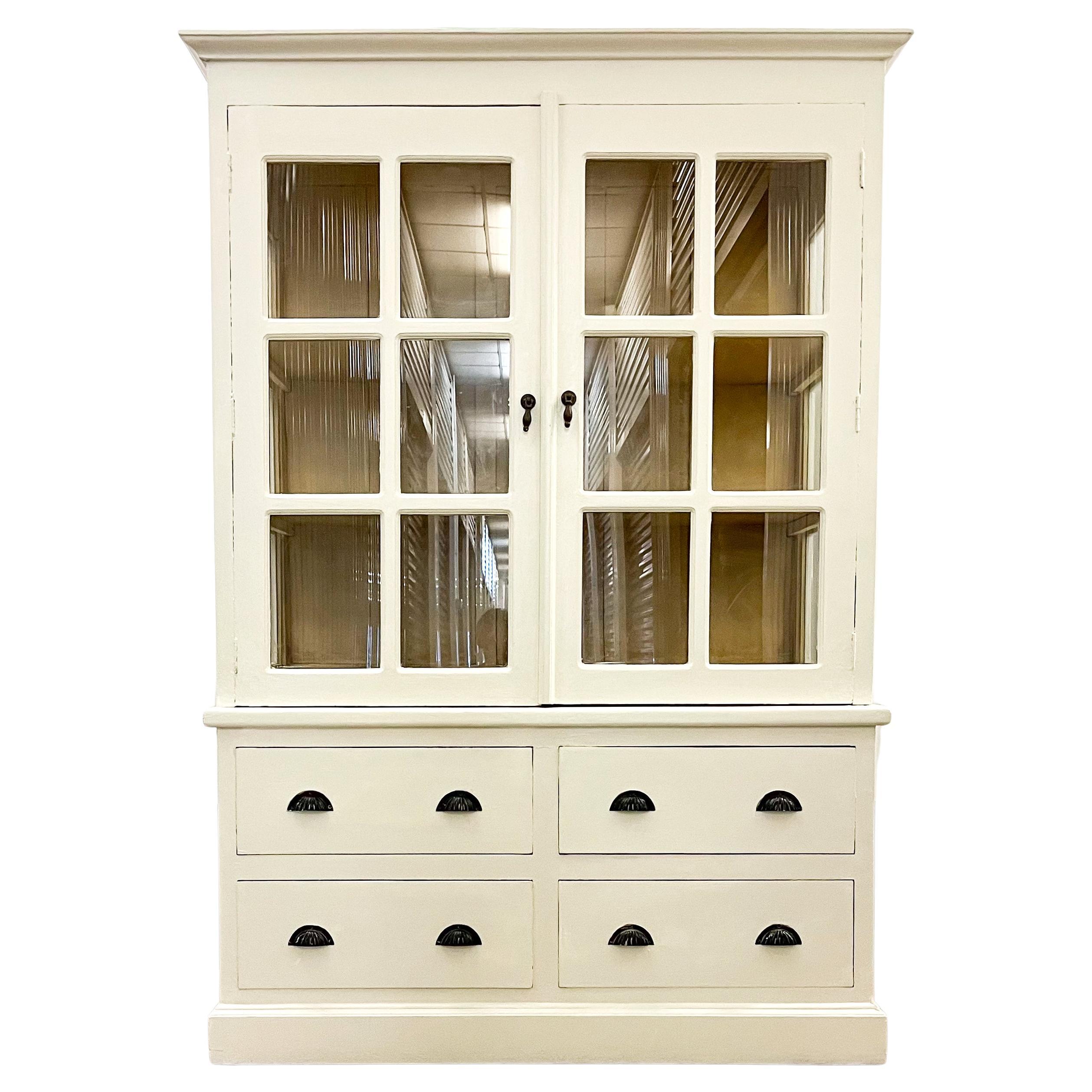 A large Painted Victorian Apothecary Style Glazed cabinet cupboard 

Splits into two parts (Top and base drawers) for ease of transportation.
Good solid construction, currently painted in a limed off-white.
Expected signs of wear, please refer