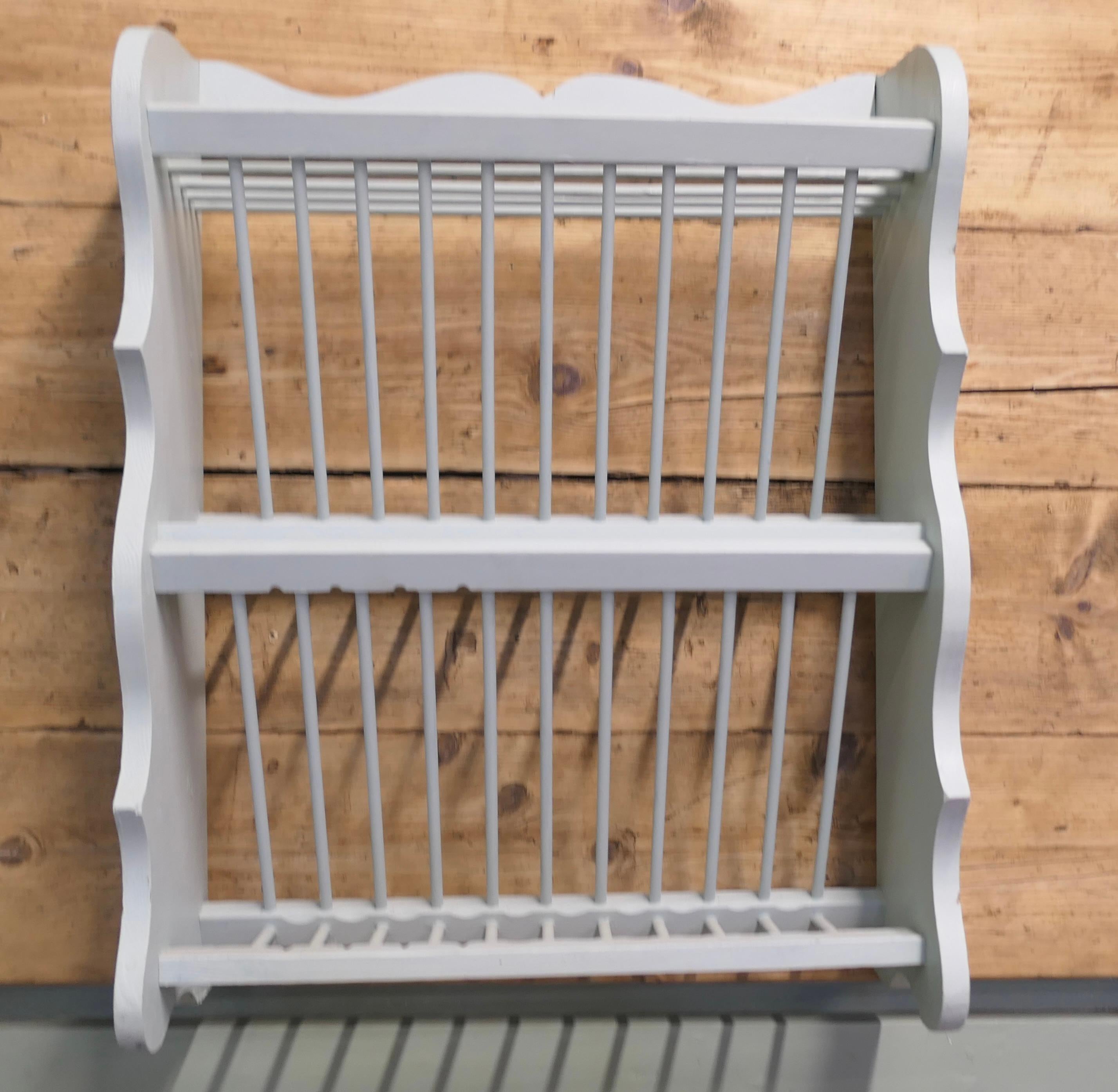 Large Painted Wall Hanging Pine Plate Rack

This useful piece hangs on the wall and drains and stores plates until required
It has a pine frame has a scalloped side, allowing 2 rows of plates to be stored at any one time
 The rack is 9” deep, 30”