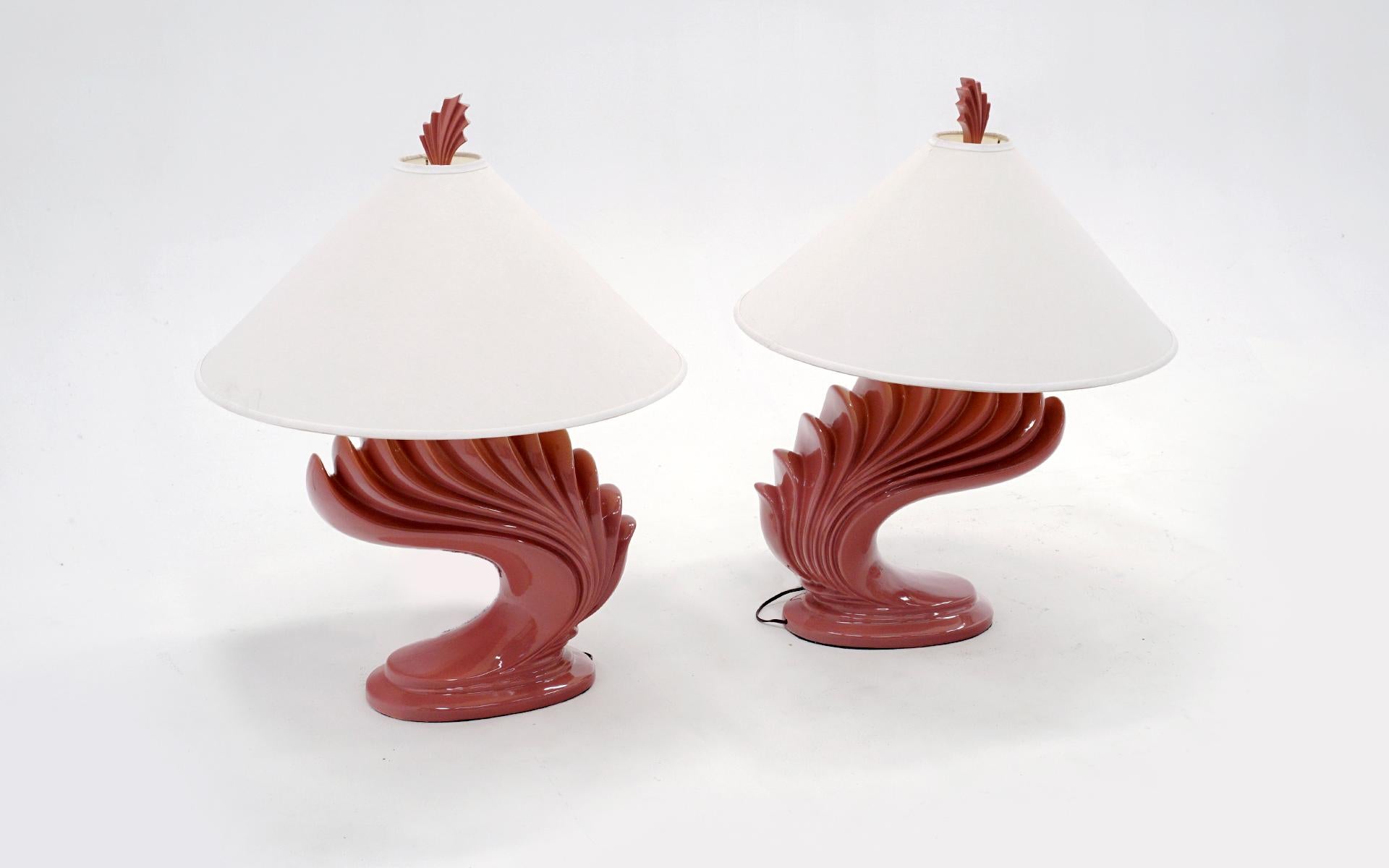Large striking pair of ceramic table lamps with the original matching finials and original lamps shades. Coral / salmon / dark pink in color. Both wired for American outlets and in working condition. Very few if any signs of use.