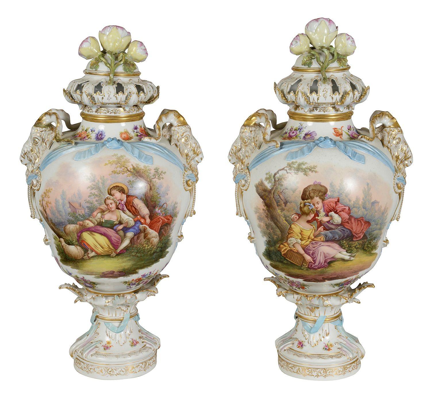 These exquisite late 19th-century pair of Berlin porcelain lidded vases showcase intricate craftsmanship and artistry. Each vase features finely painted scenes depicting pastoral life, with charming figures engaged in serene activities. The vibrant