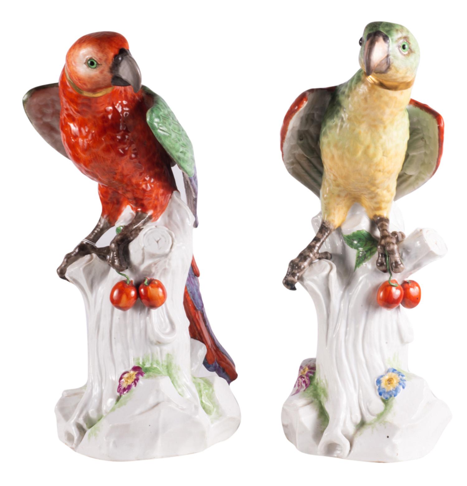 A very impressive pair of 19th century Dresden porcelain parrots, each in wonderful bold colors, set on tree stumps and holding cherries.
       