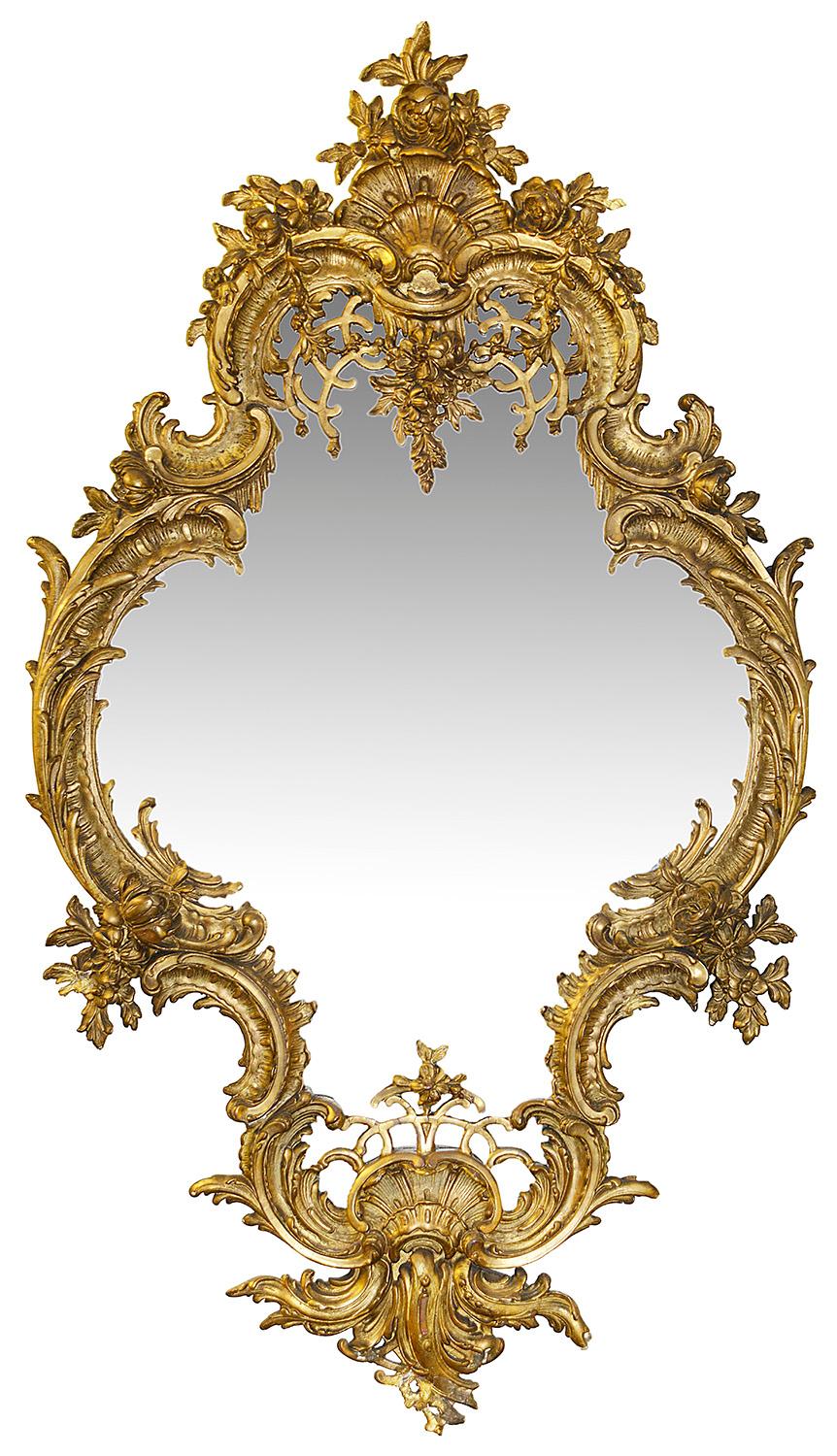 A wonderfully impressive pair of 19th century Rococo style carved gilt gesso wall/pier glass mirrors. Each with scrolling 'C' scroll, foliate and pierced trellis decoration. Measure: 58