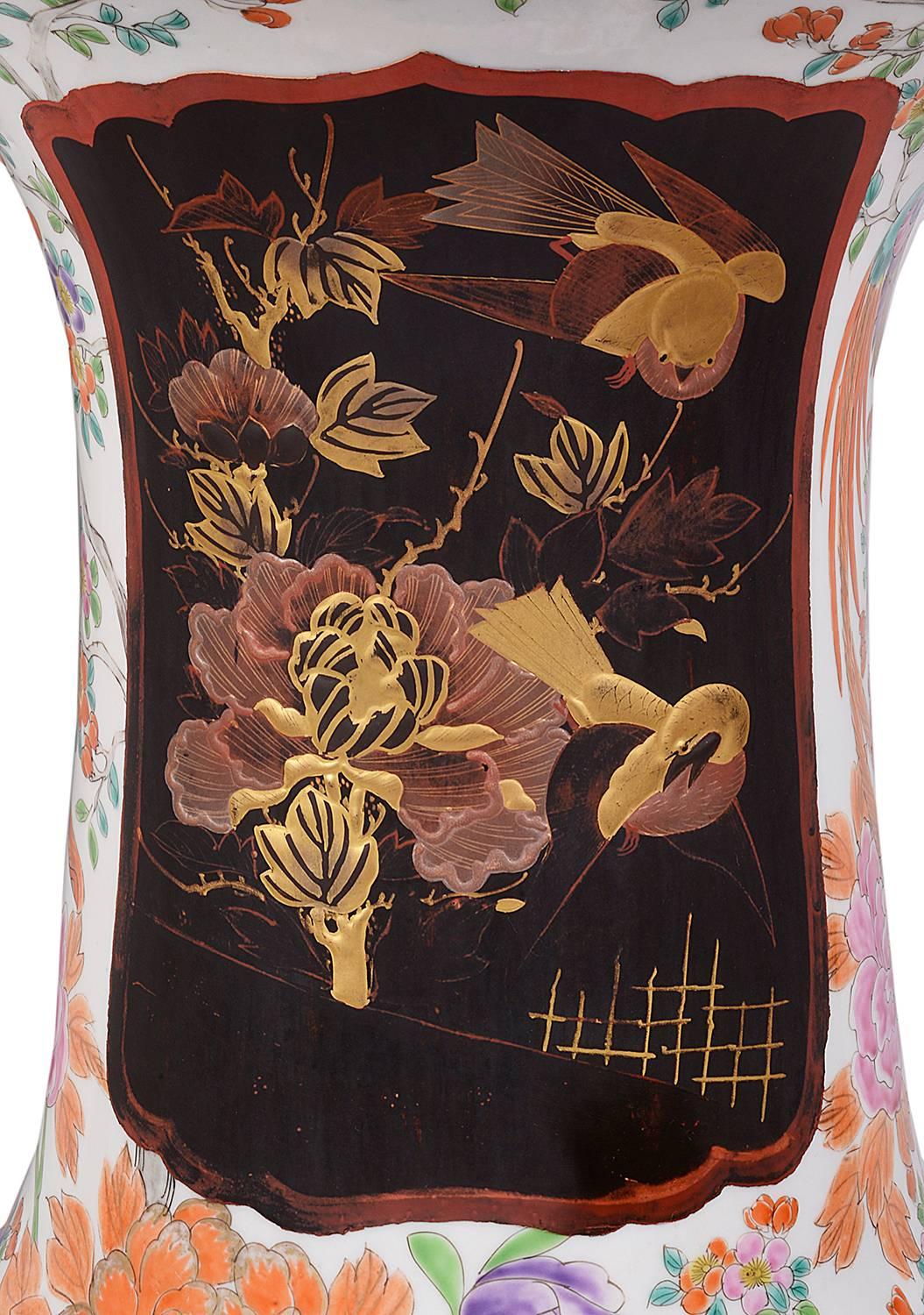 A good quality pair of large 19th century Japanese flared neck Arita vases, each with lacquered panels depicting scenes of two girls in the garden, surrounded by birds and flowers.