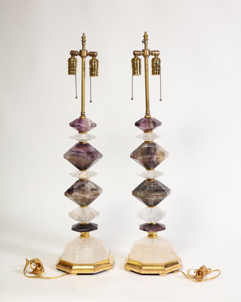 A Very Fine Pair of French Geometric Shape Hand Diamond Cut Rock Crystal and Amethyst Rock Crystal Table Lamps from the 1900s.  These Fabulous  lamps embody a harmonious blend of exquisite craftsmanship and natural beauty. Adorned with a symphony of
