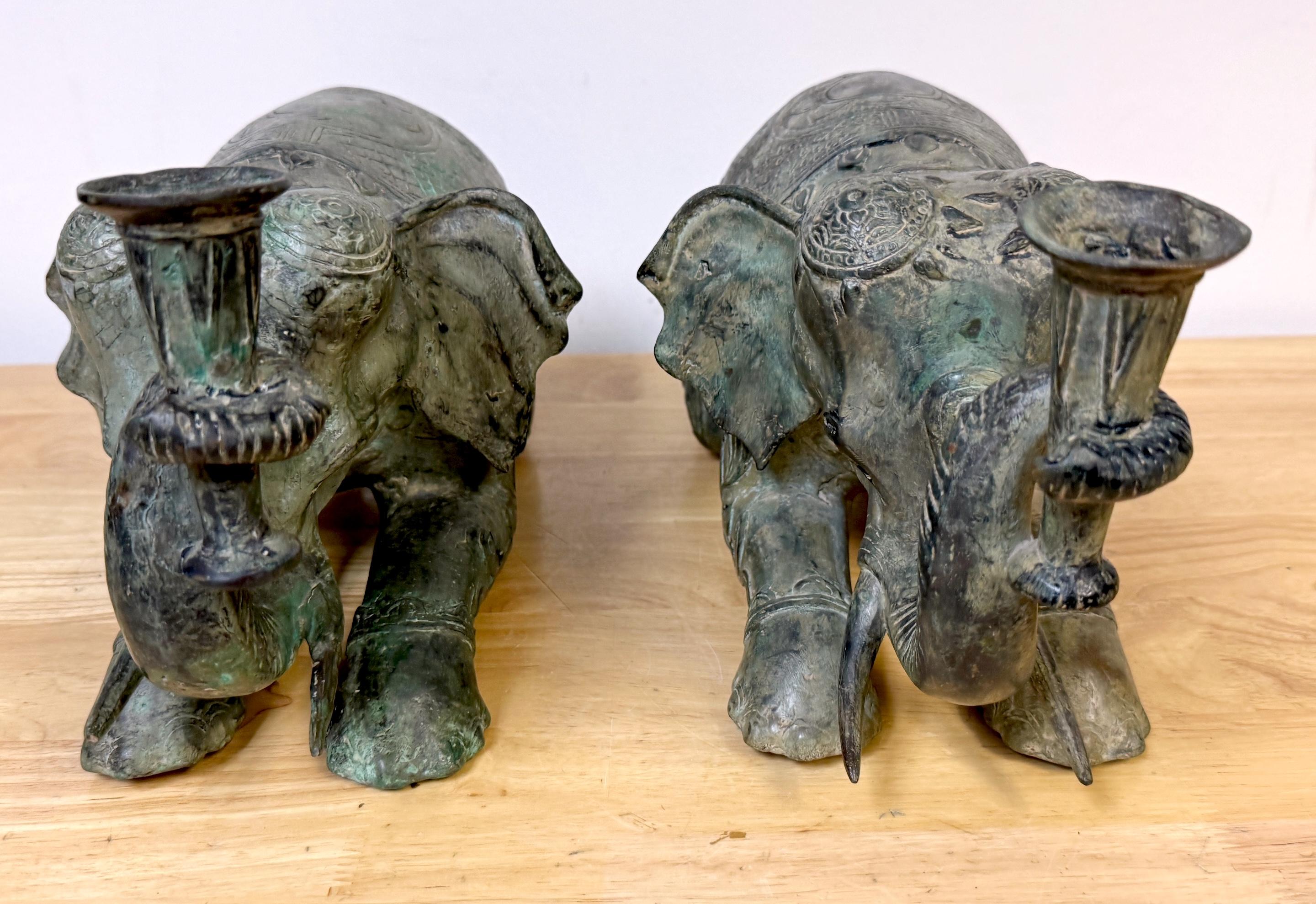 Cast Large Pair Asian Bronze Recumbent Processional Elephant Motif Candlesticks For Sale