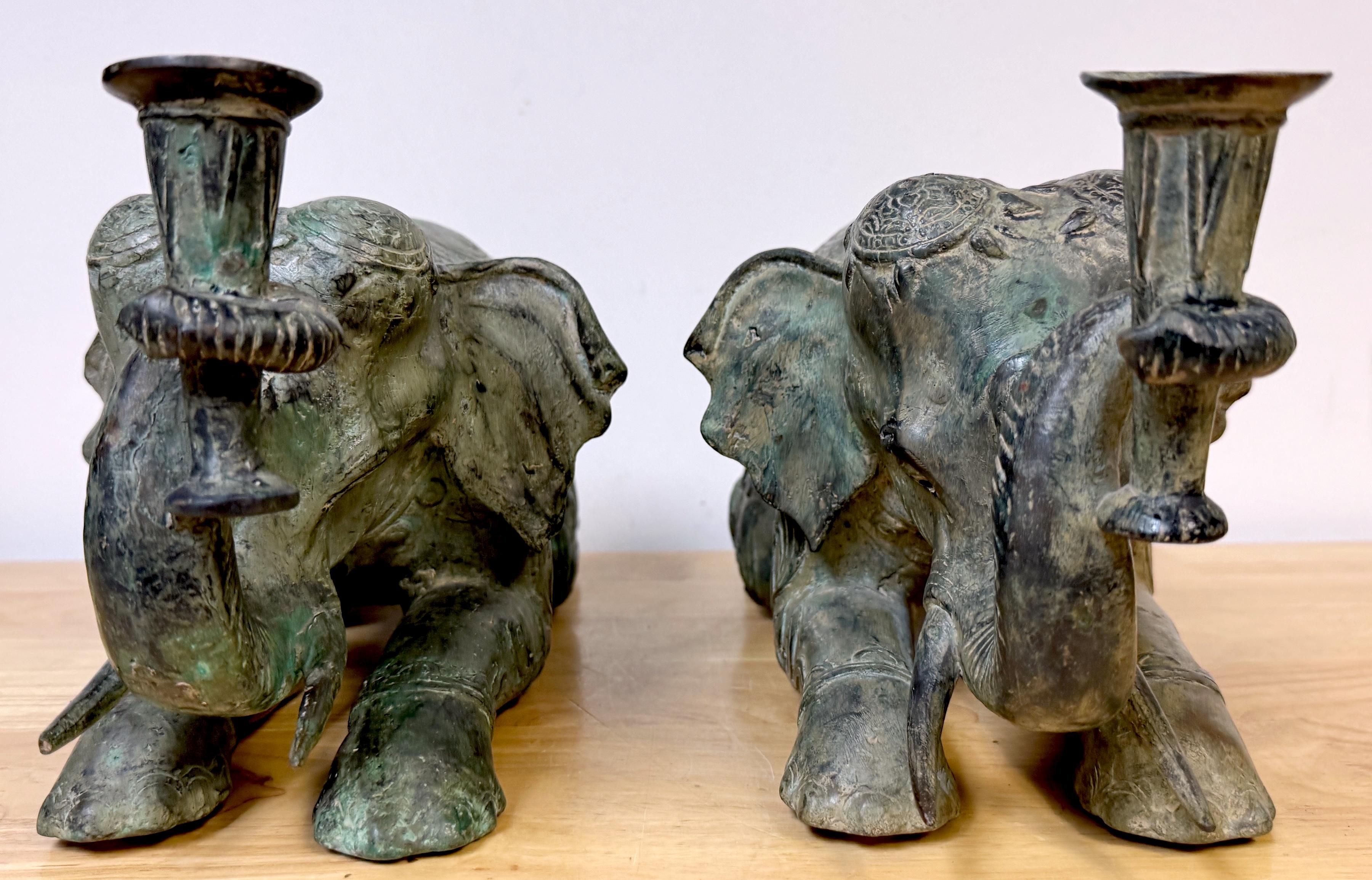 Large Pair Asian Bronze Recumbent Processional Elephant Motif Candlesticks In Good Condition For Sale In West Palm Beach, FL