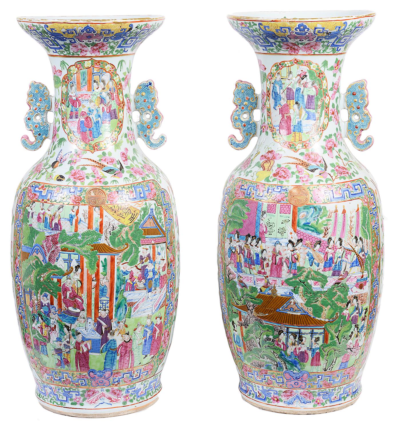 An imposing and very good quality pair of Cantonese / rose medallion vase. Each having wonderful bold colors, the inset hand painted panels depicting interior scenes of courtiers and their attendants, bordered by classical motif, flowers and
