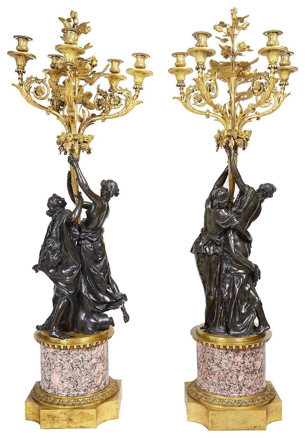 A very impressive good quality pair of 19th century classical bronze and ormolu candelabra, each with ormolu roses, leaves and four scrolling foliate branches, supported by a pair of classical semi nude maidens, raised on gilded ormolu-mounted