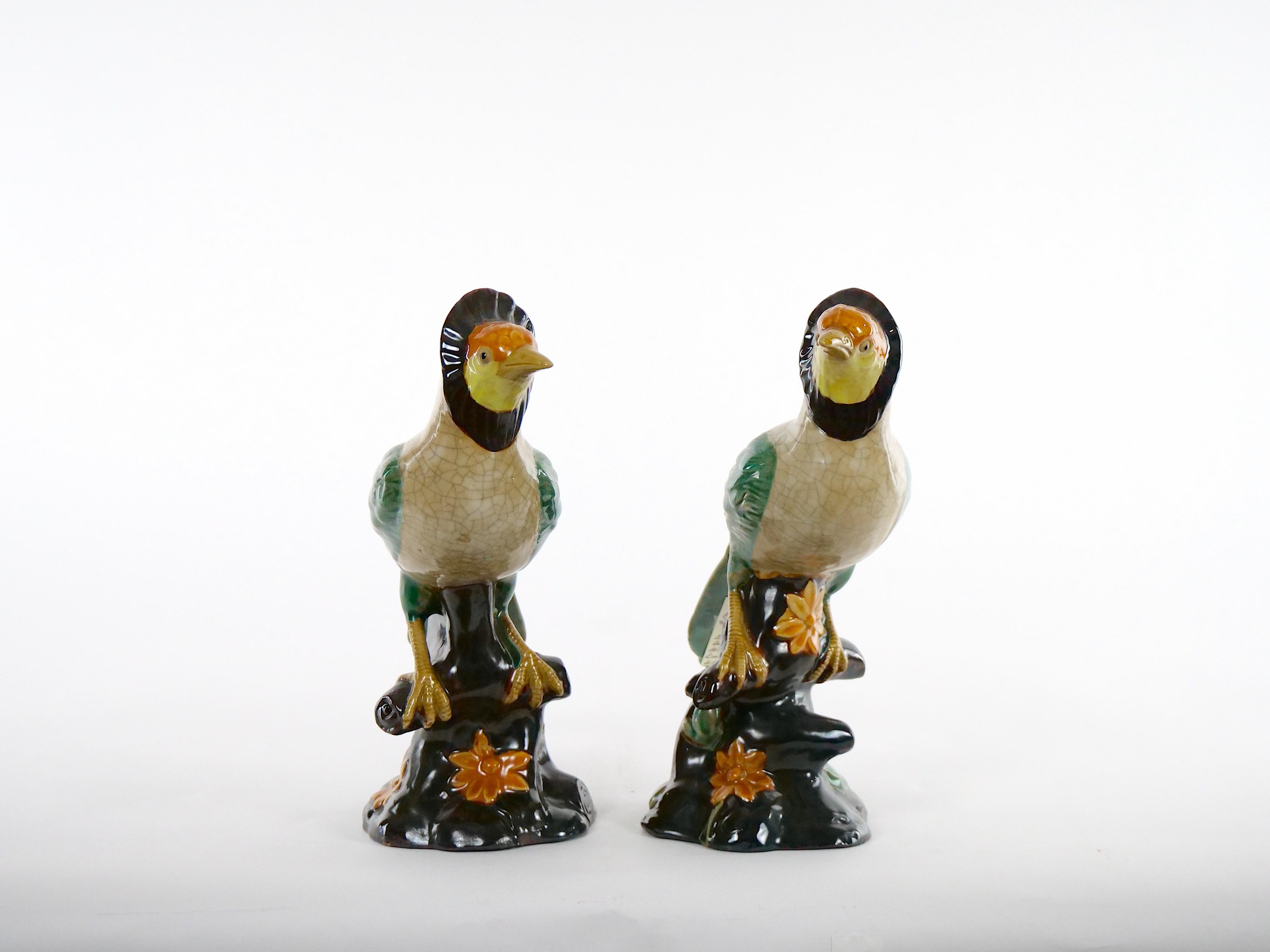 Beautiful English porcelain / terracotta hand painted and glazed decorated pair of decorative tableware bird statues. This stunning large pair of English glazed porcelain tableware decorative birds are executed in vibrant colors of orange , brown,