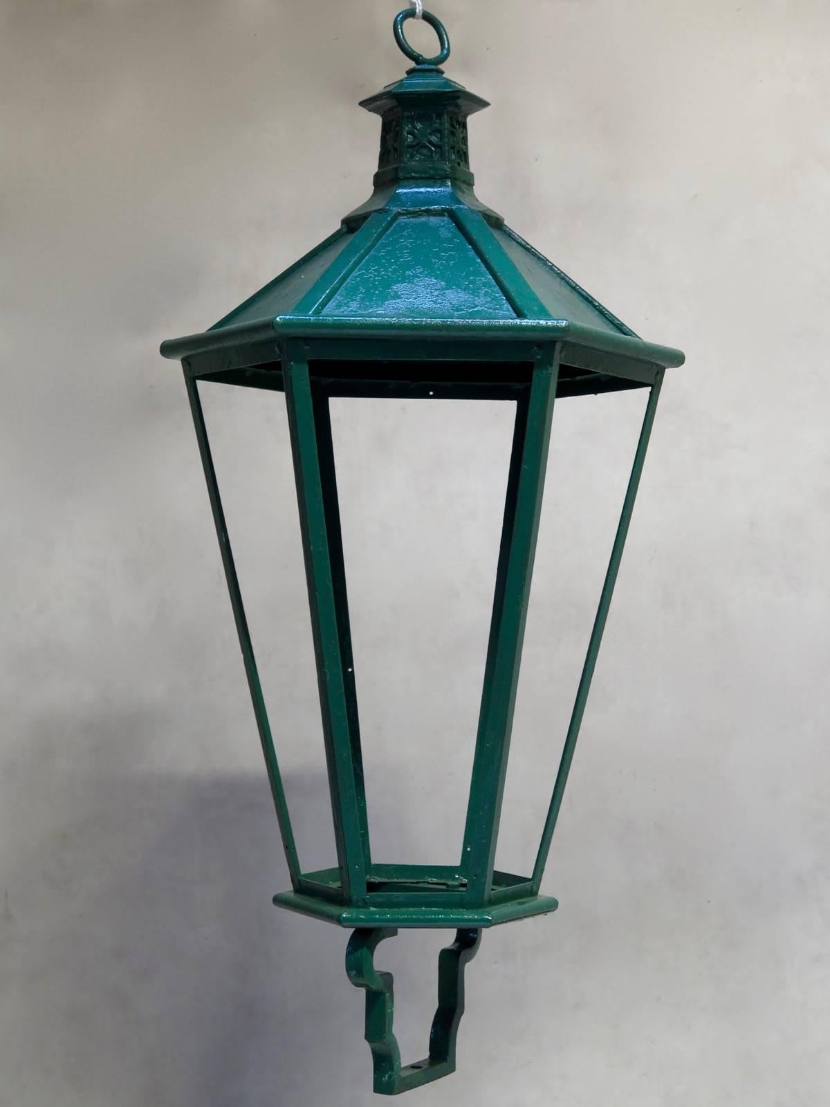 Very large and elegant pair of iron hanging lanterns, painted green. Glass panels could be added (either colored ones or clear).