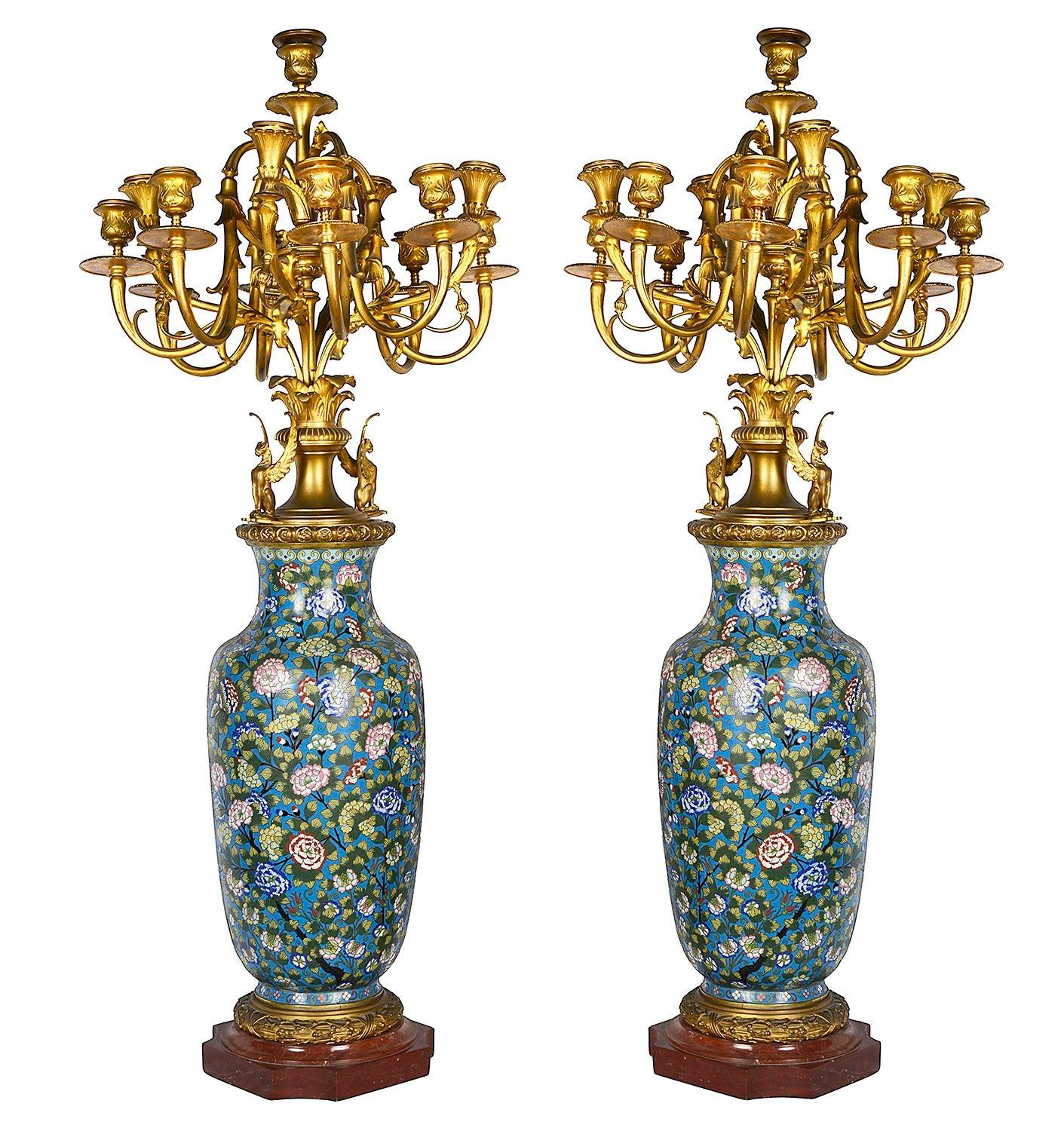 A wonderful quality pair of late 19th Century French Cloisonné enamel and gilded ormolu 12 branch candelabra. Having wonderful bold colouring to the floral design enamel decoration, mounted on Rouge marble plinth bases.
In the manner of Ferdinand