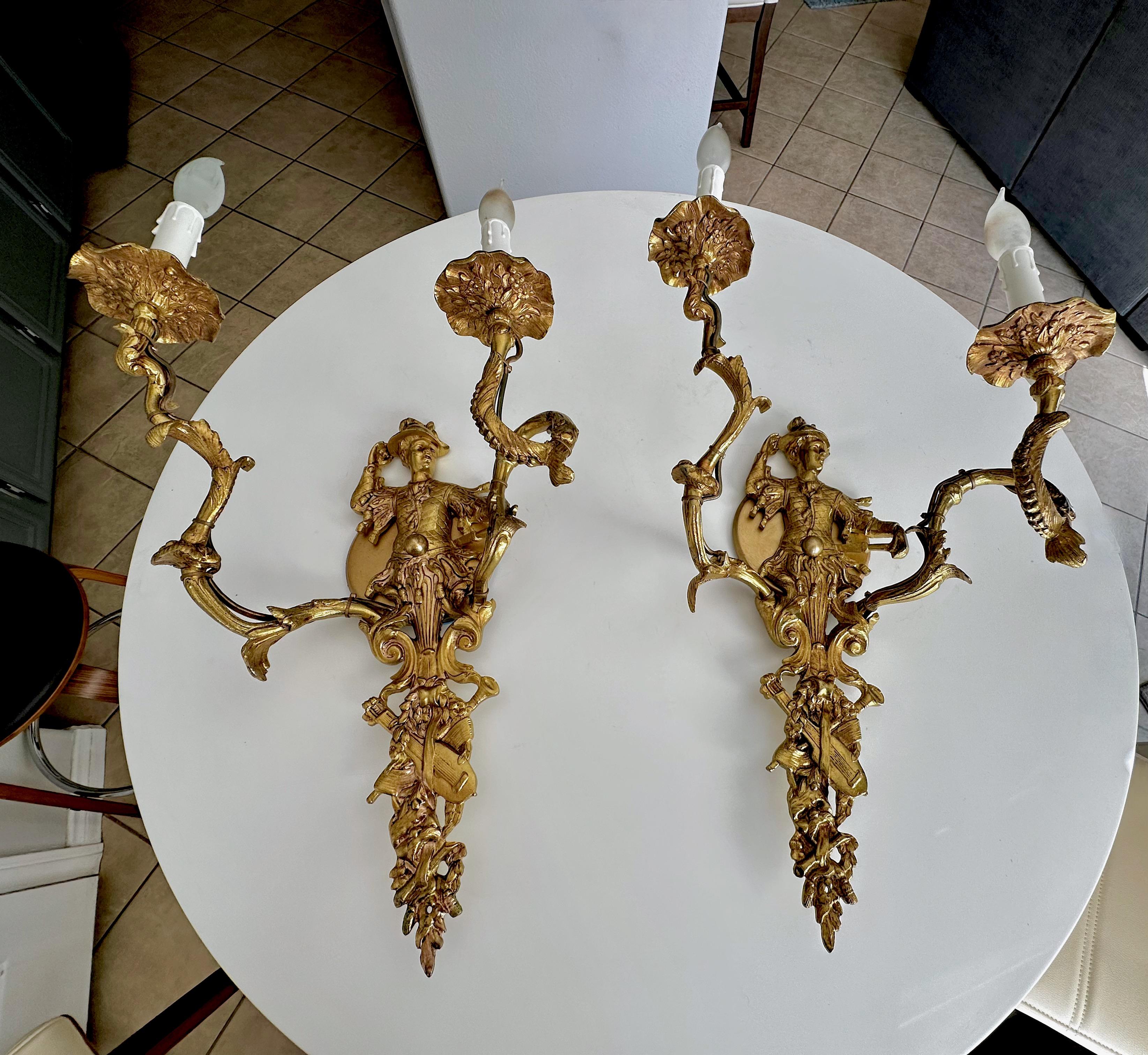 Pair of large French XV chinoiserie style gilt bronze (or brass) wall sconces with male figural motif. The sconces are nicely crafted with fine detailing throughout. Each uses 2 candelabra size bulbs. Newly wired for US installation.
