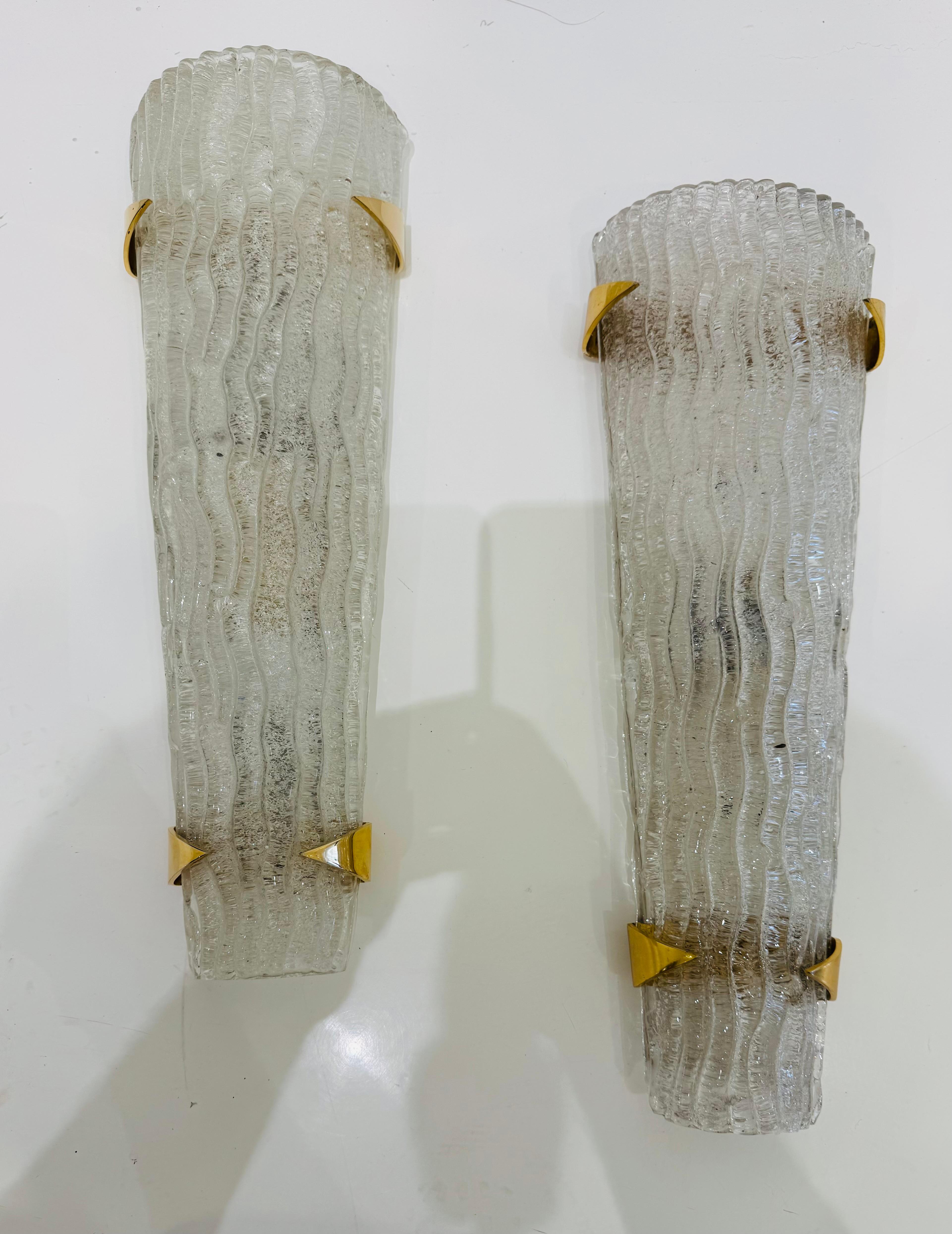A pair of large luxurious  French Mid Century sconces composed of thick ribbon Murano glass shades and pointed brass holder by famed French lighting company, Madison Arlus.. Rewired.  Two candelabra sockets each.