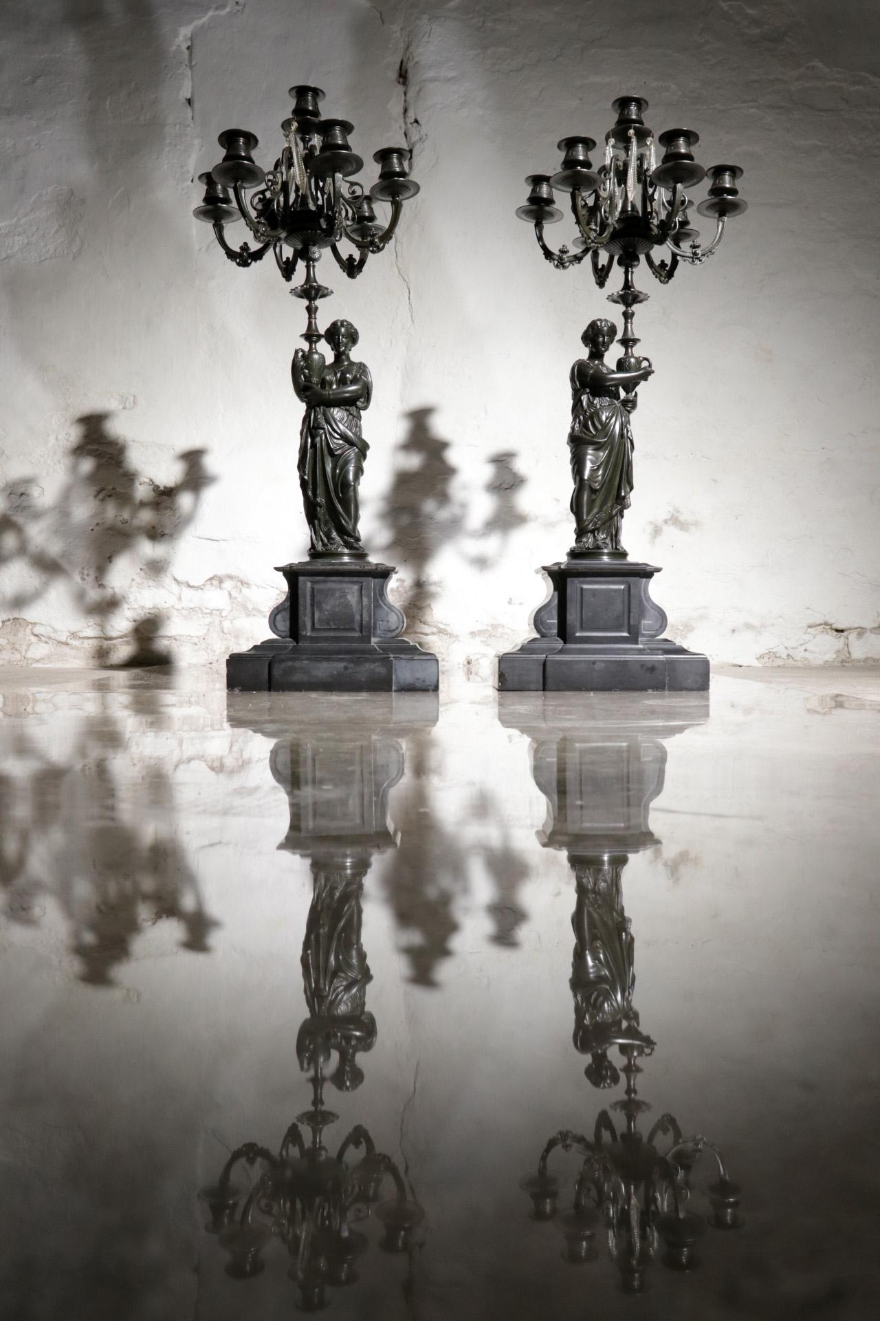Very decorative, large (almost 80 cm high) pair of France candelabra from in the 19th century.
Made of patinated bronze and standing on a marble base.
Very detailed figures. Some crystals hang in the candlesticks that provide the sparkle when the