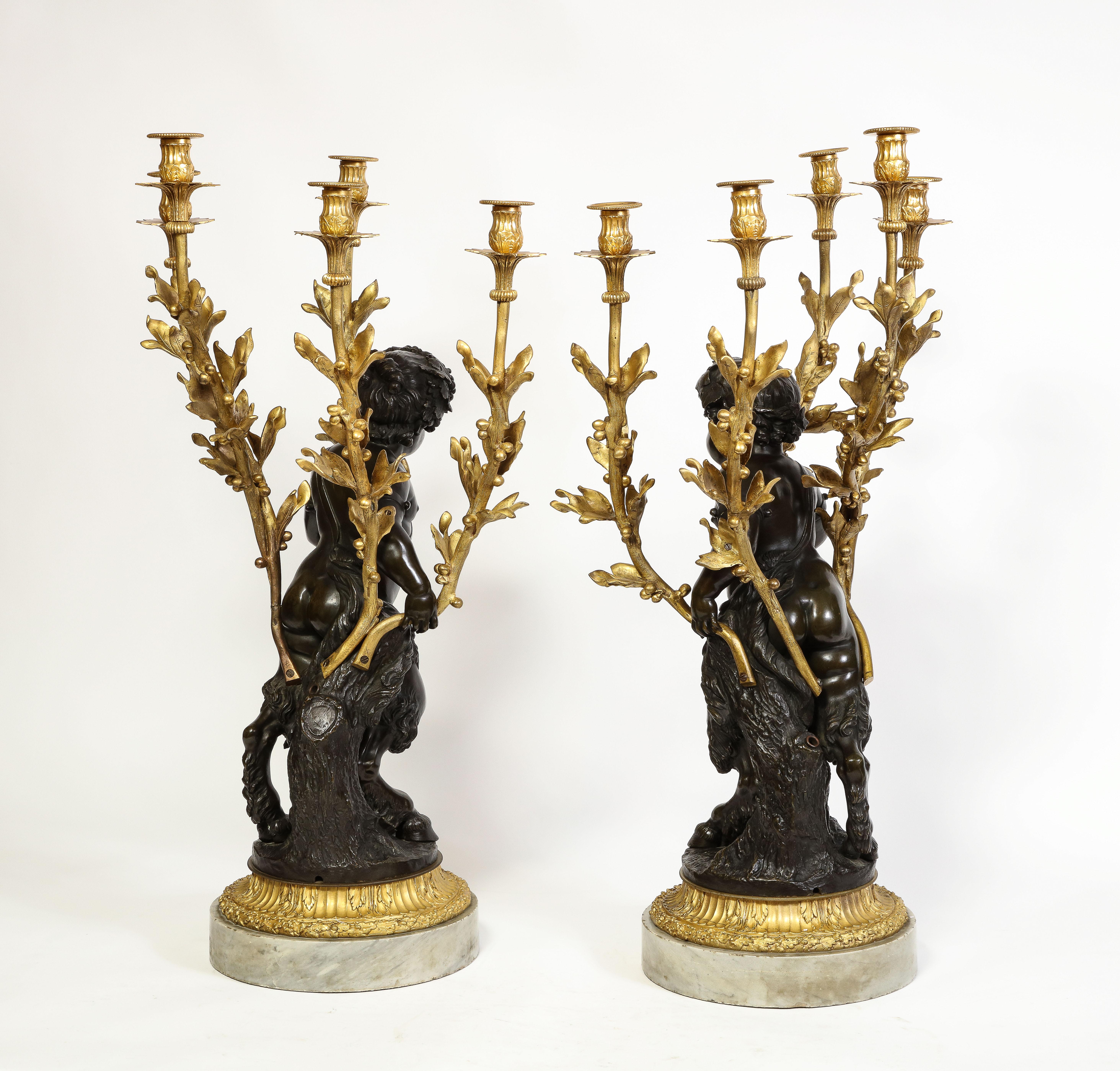 Hand-Carved Large Pair French Patinated & Dore Bronze Putti Form Candelabra on Marble Bases For Sale