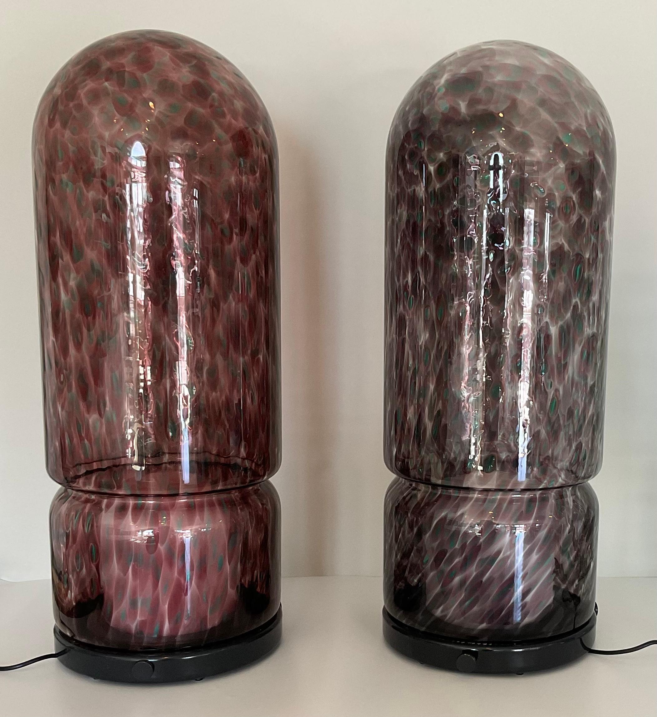 Rare pair of Vistosi Glicene De Terra Murrine table lamps or floor lamps in plum. These lamps were designed by Gae Aulenti and are seldom seen on the open market. Finding a pair is virtually impossible. These lamps are new old stock and have been in