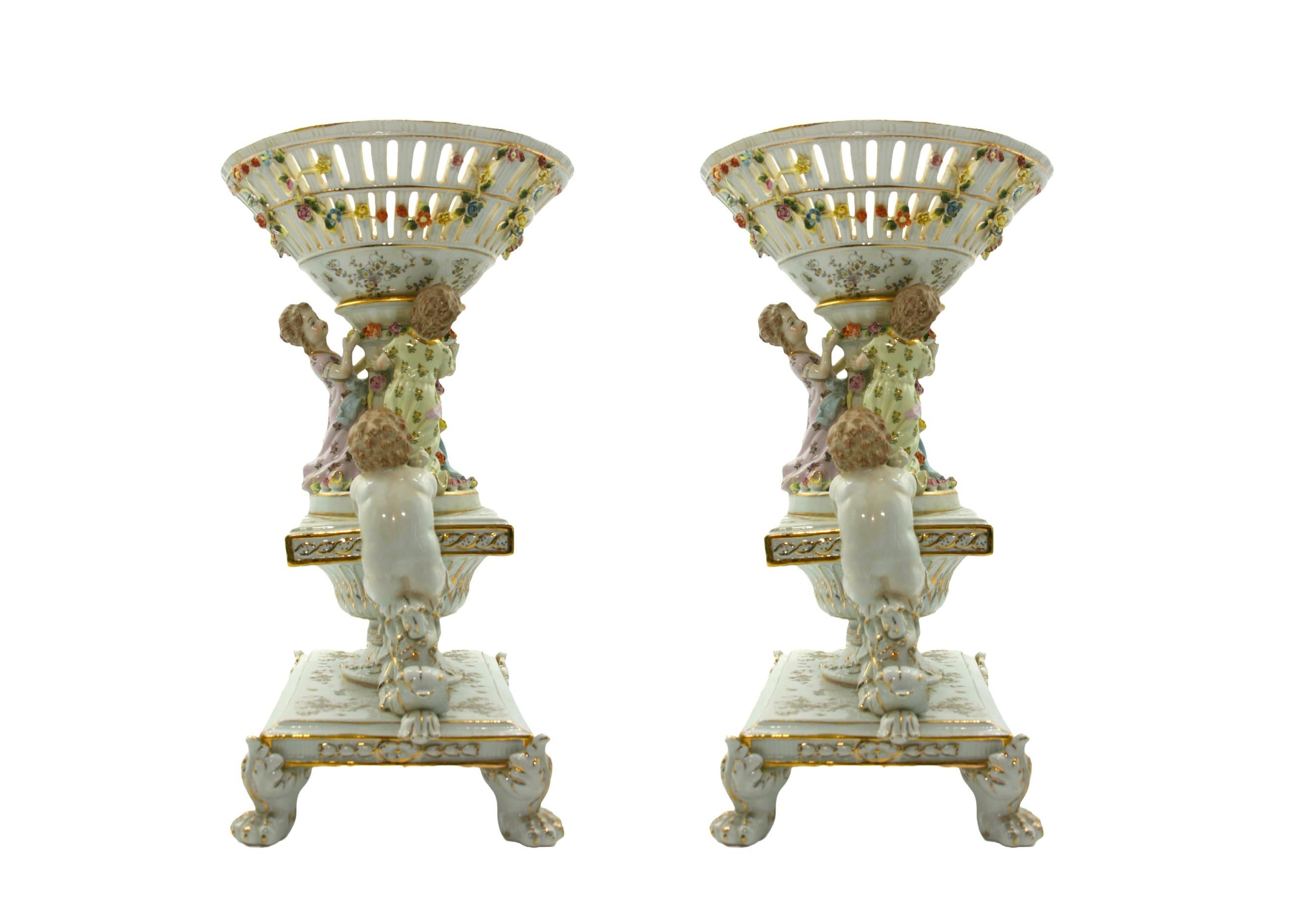 Stunning and beautifully decorated hand painted German porcelain large pair of decorative centerpieces with gold accents . Each centerpiece is in excellent condition . Minor wear consistent with age / use . Each one measures 19 inches tall X 14 1/2