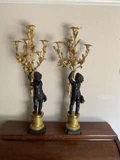 large pair gilt and patinated cherub candelabra