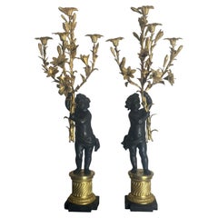 large pair gilt and patinated cherub candelabra