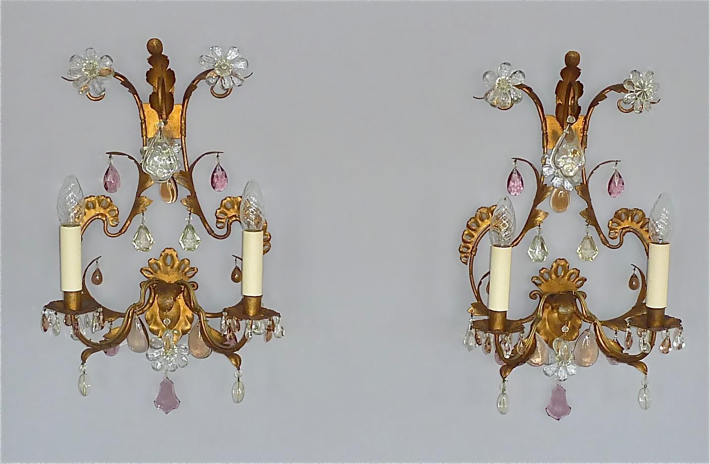 Large refined pair of floral Maison Baguès Style leaf sconces or wall lights, France circa 1950s. They are made of gilt iron / metal combined with beautiful faceted crystal glass in clear, amethyst and light brown color with sparkling glass beads