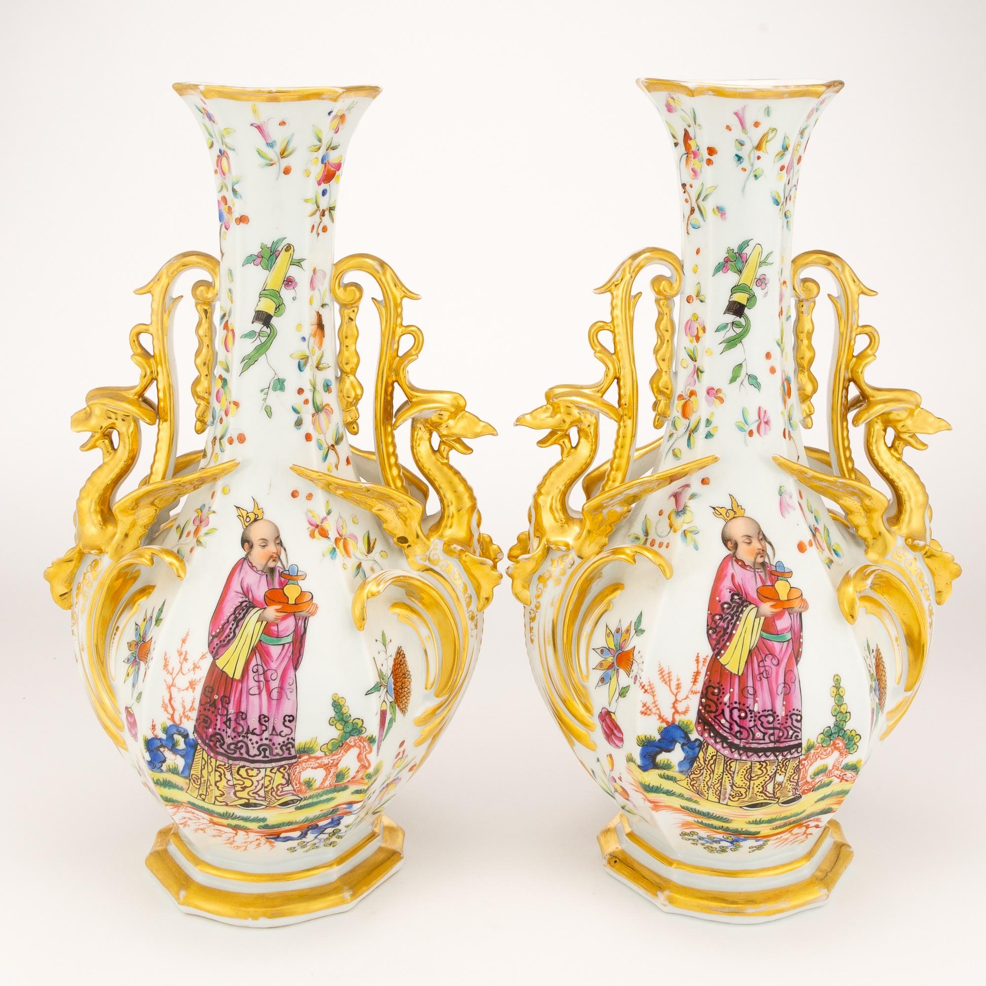 Enhance your space in the timeless elegance of the late 19th Century Pair of Gilt and Polychrome Porcelain Vases. Crafted with meticulous attention to detail, each vase boasts a bottle form with beautifully paneled sides and dragon-form handles,