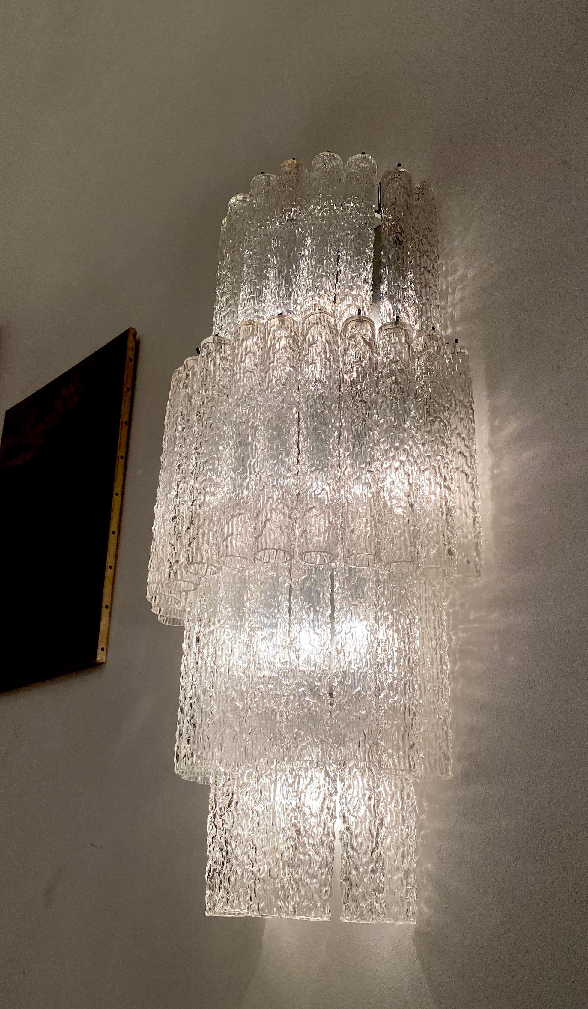 Pair of monumental wall lights composed by dozens of precious 'Tronchi' Murano glasses on four levels with clear color glasses.
Available 2 pairs of sconces and an outstanding chandelier from the same provenance. 
 
     
  