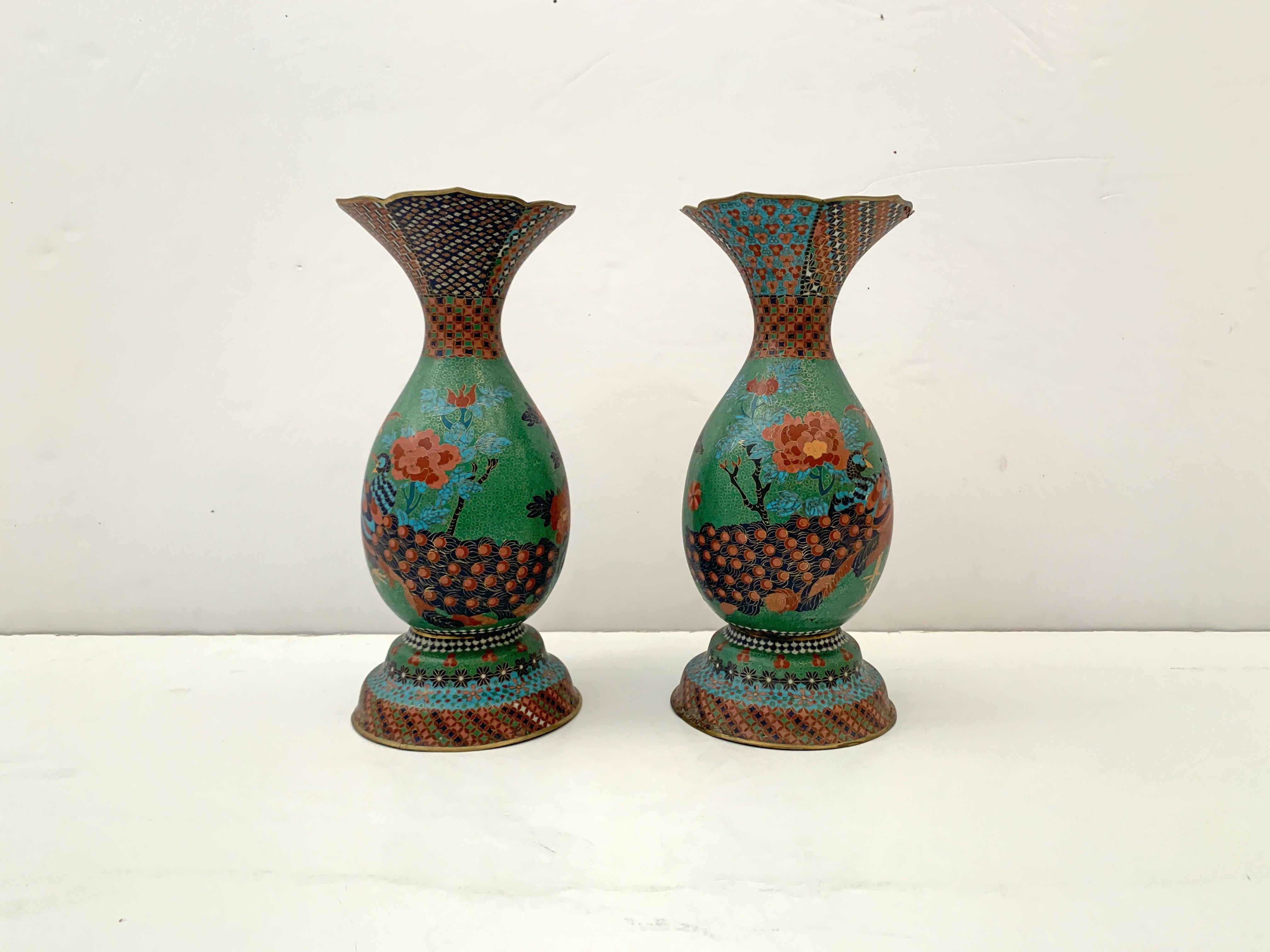 An impressive pair of Japanese cloisonné peacock vases attributed to Kaji Tsunekichi (1803 - 1883), Meiji period, mid-19th century, Japan. 

The vases of pear shape, with a high splayed foot and large everted trumpet mouth. The bodies with a