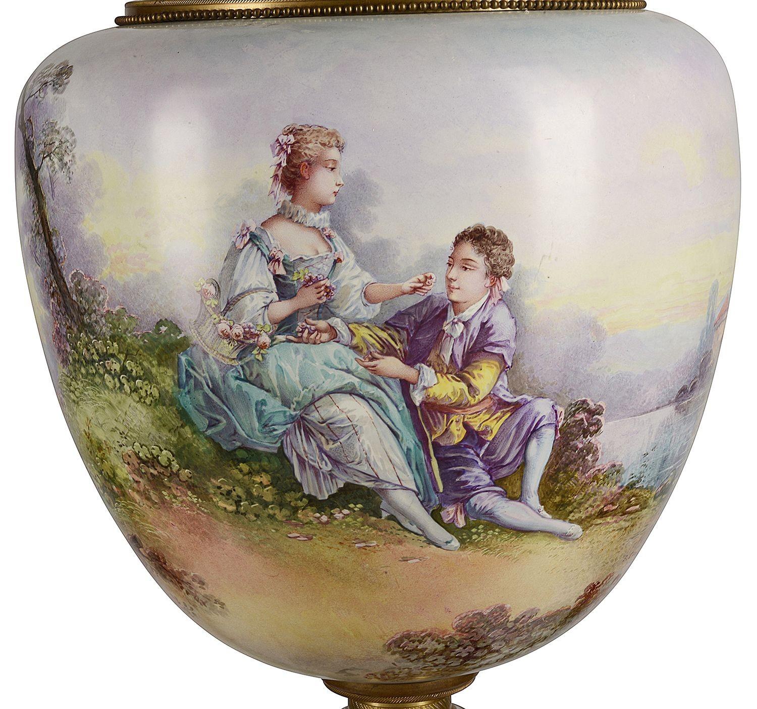 A very good quality pair of late 19th Century French 'Sevres' style porcelain lidded vases, each with cobalt blue ground, high lighted with classical gilded decoration. Romantic scenes of lovers courting, signed E. Carell, rural scenes to the