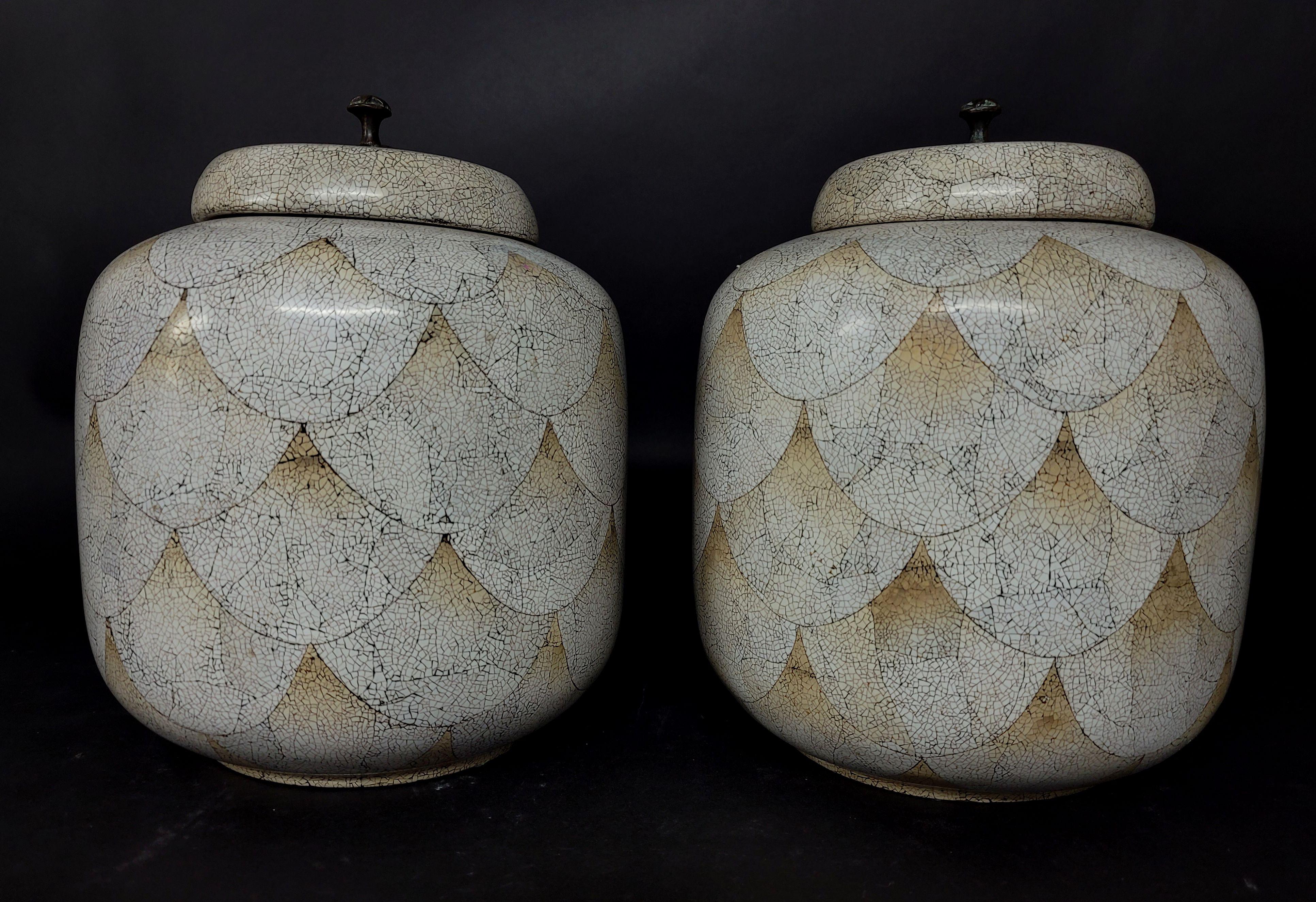 Large pair of Maitland Smith white and tan cloisonne lidded ginger jars.
They have the crackle pattern throughout the whole body to imitate the cloisonné copper lines.

  