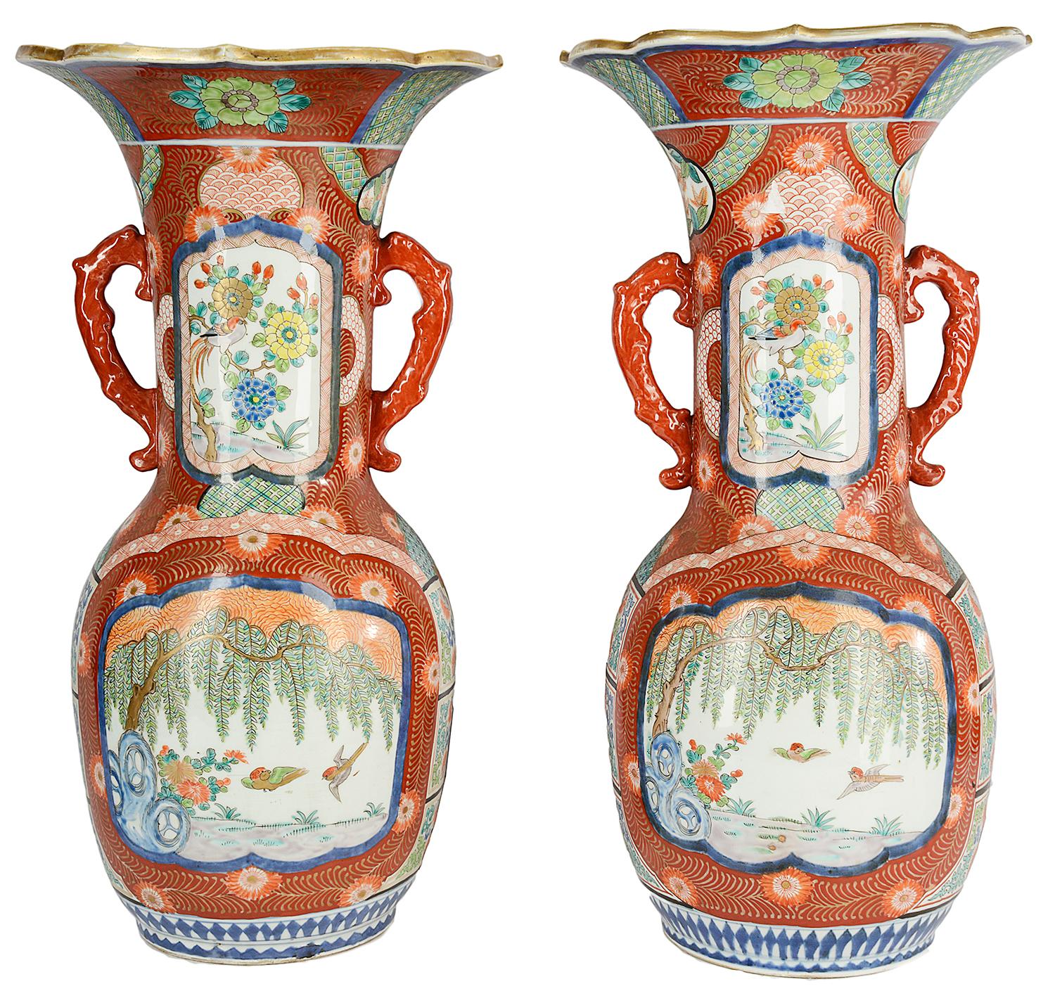 A very decorative and impressive Meiji period (1868-1912) Japanese Kutani flare necked twin handle vases. Each with orange ground feather decoration, inset painted panels with blossom trees, birds and flowers.
This pair of vases we can convert to