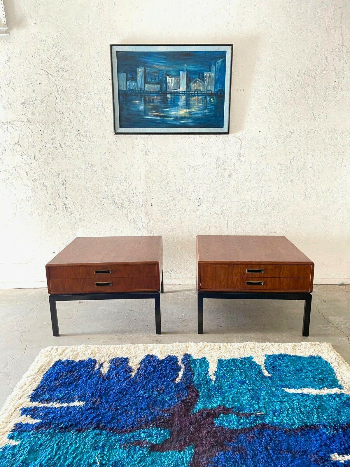 A gorgeous pair of founders Mid-Century Modern Danish style end tables. Beautiful American black walnut with gorgeous wood grain through out. The drawers feature brass pulls. These well made pieces combine timeless danish modern elegance with